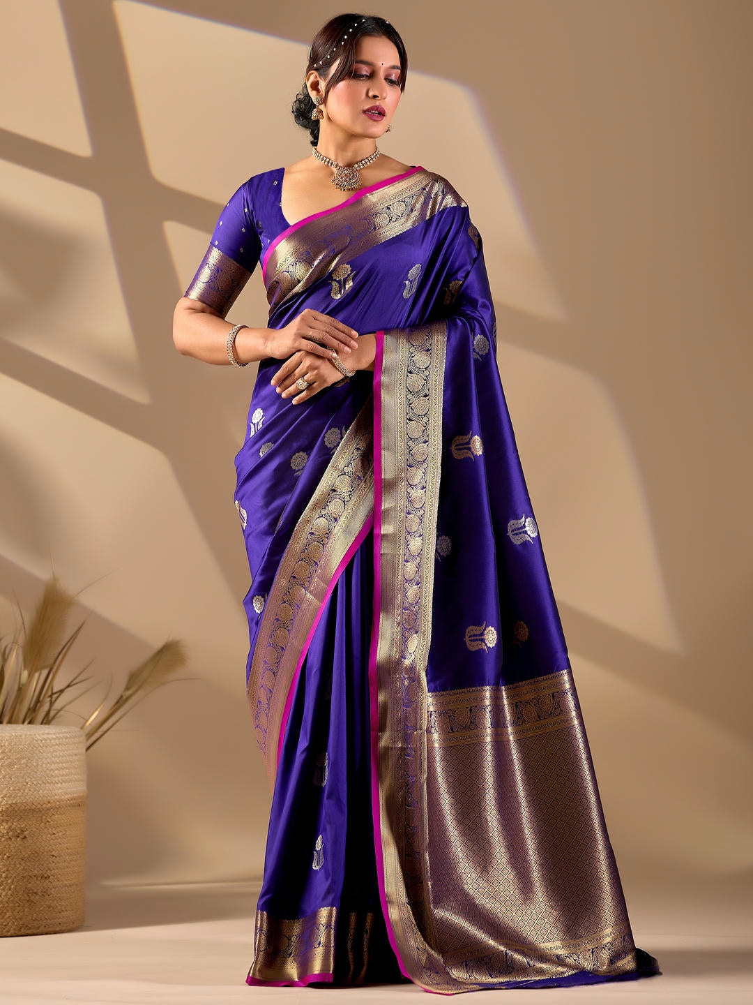 Beautiful woman styled in a blue woven design silk saree featuring a heavy zari border and solid blouse by Samantha.