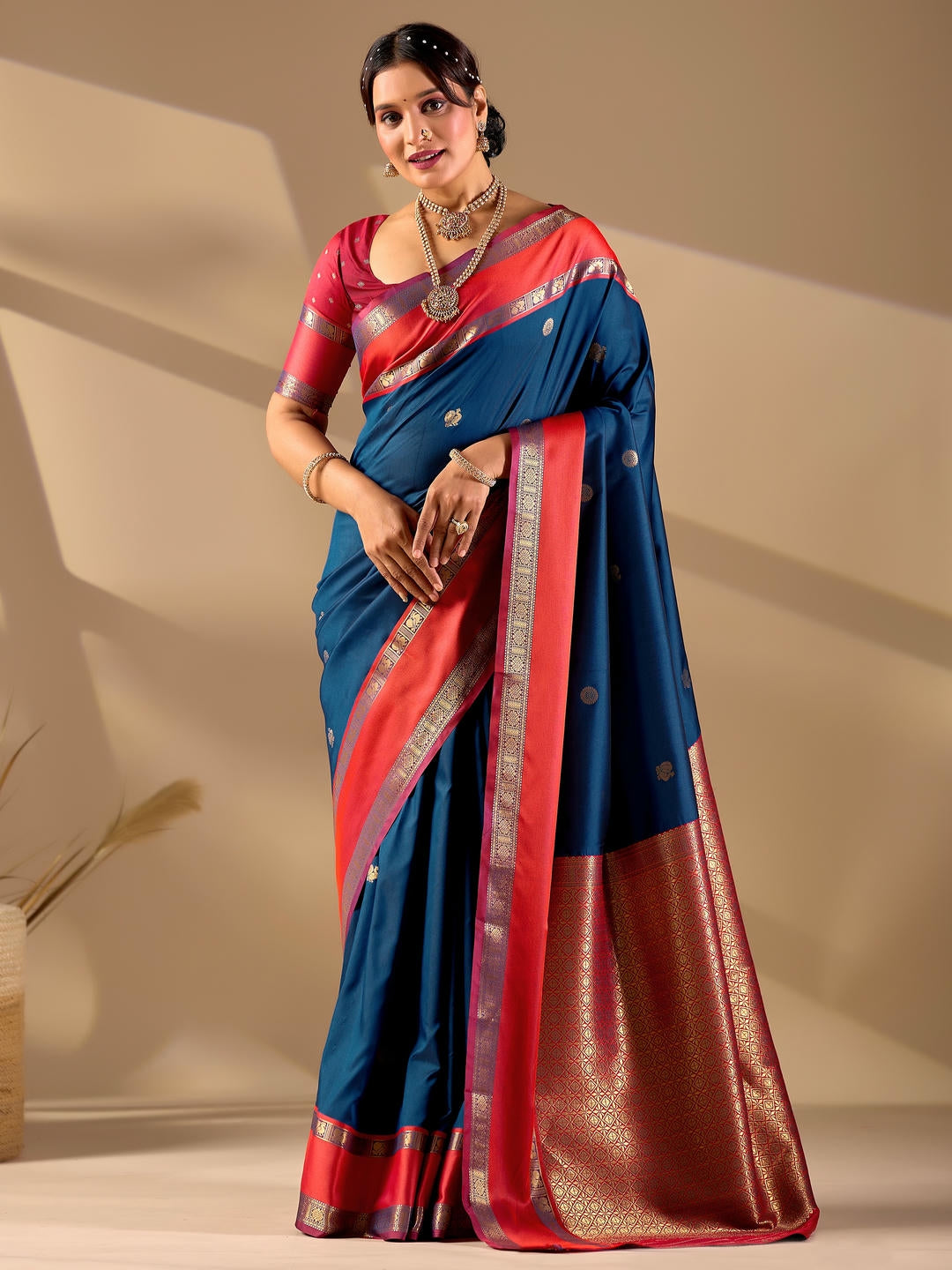 Beautiful woman styled in a metallic grey woven design silk saree featuring a heavy zari border and solid blouse by Samantha.