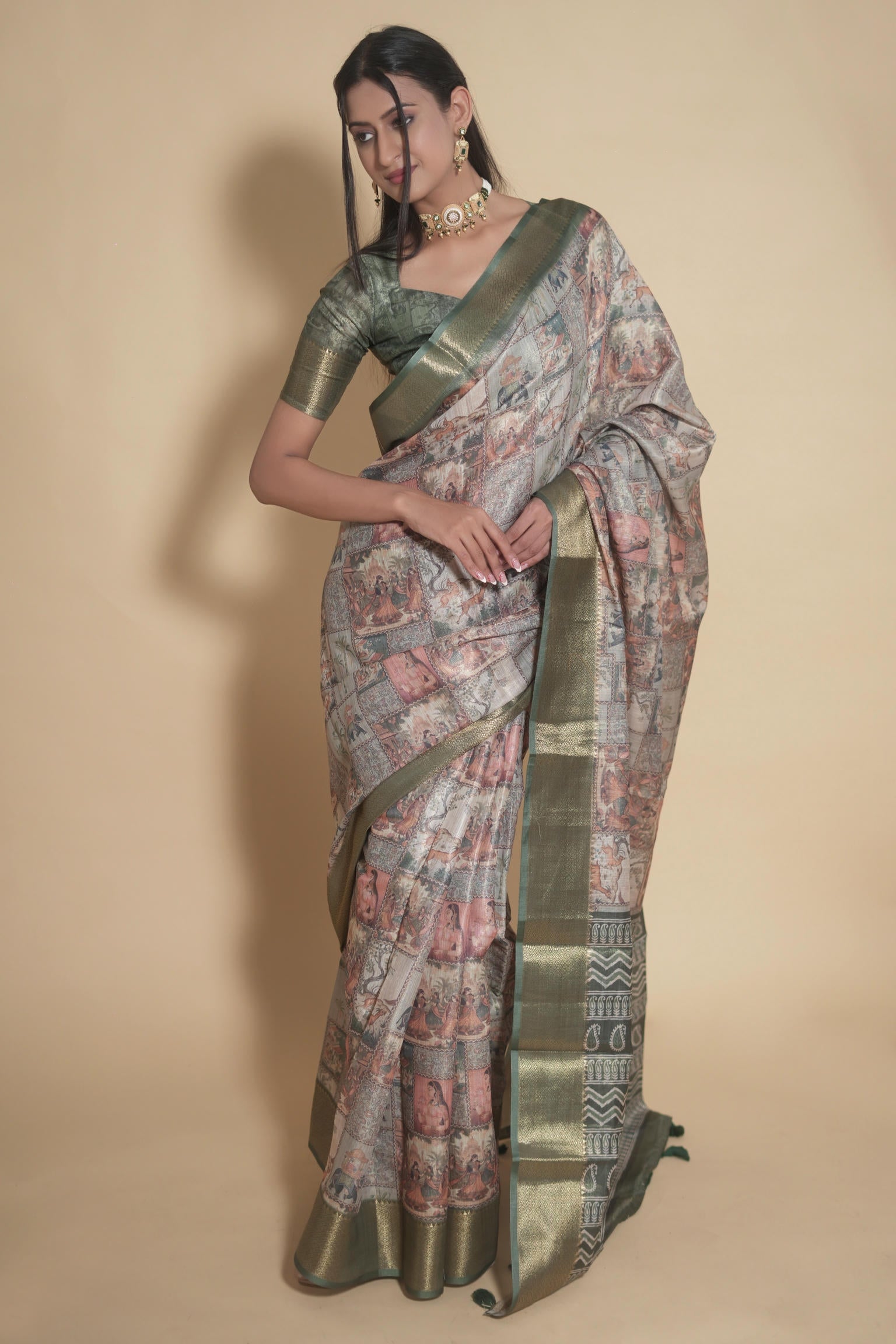 Earthy multi-tone Kalamkari print saree with antique gold zari border and sage green blouse