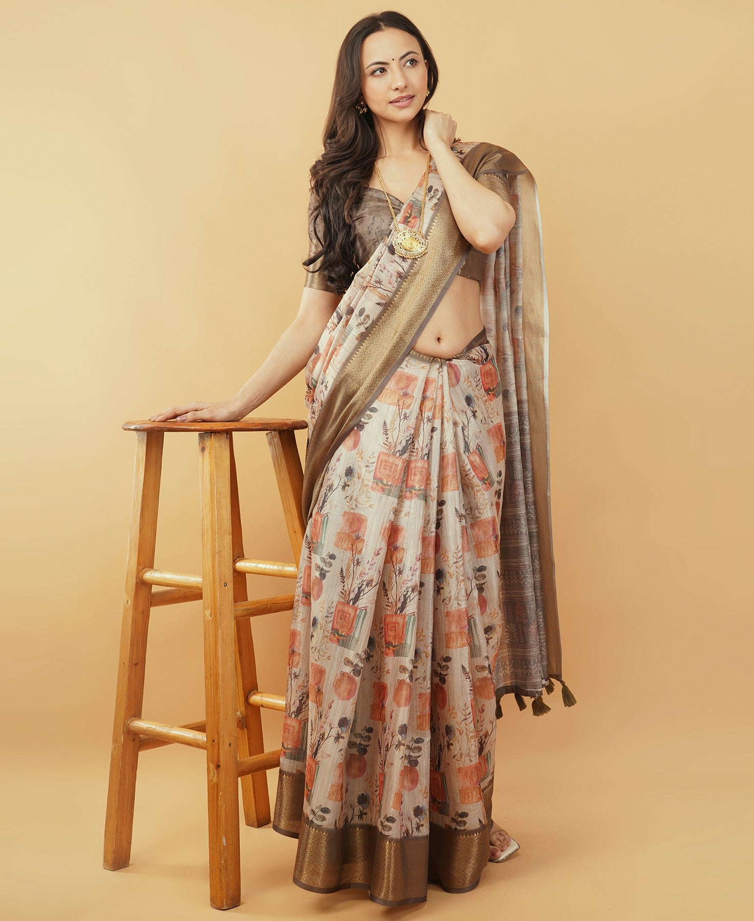 Cream and rust botanical print saree with bronze zari border