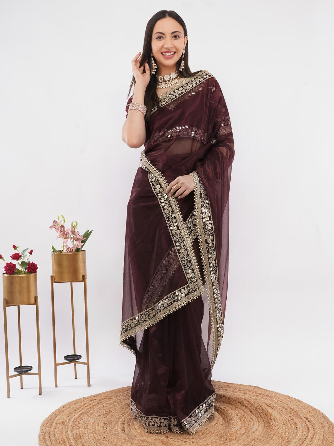 Beautiful woman styled in a classic chocolate brown nettwill sheer saree featuring elegant tonal embroidery and a matching unstitched blouse by Samantha.
