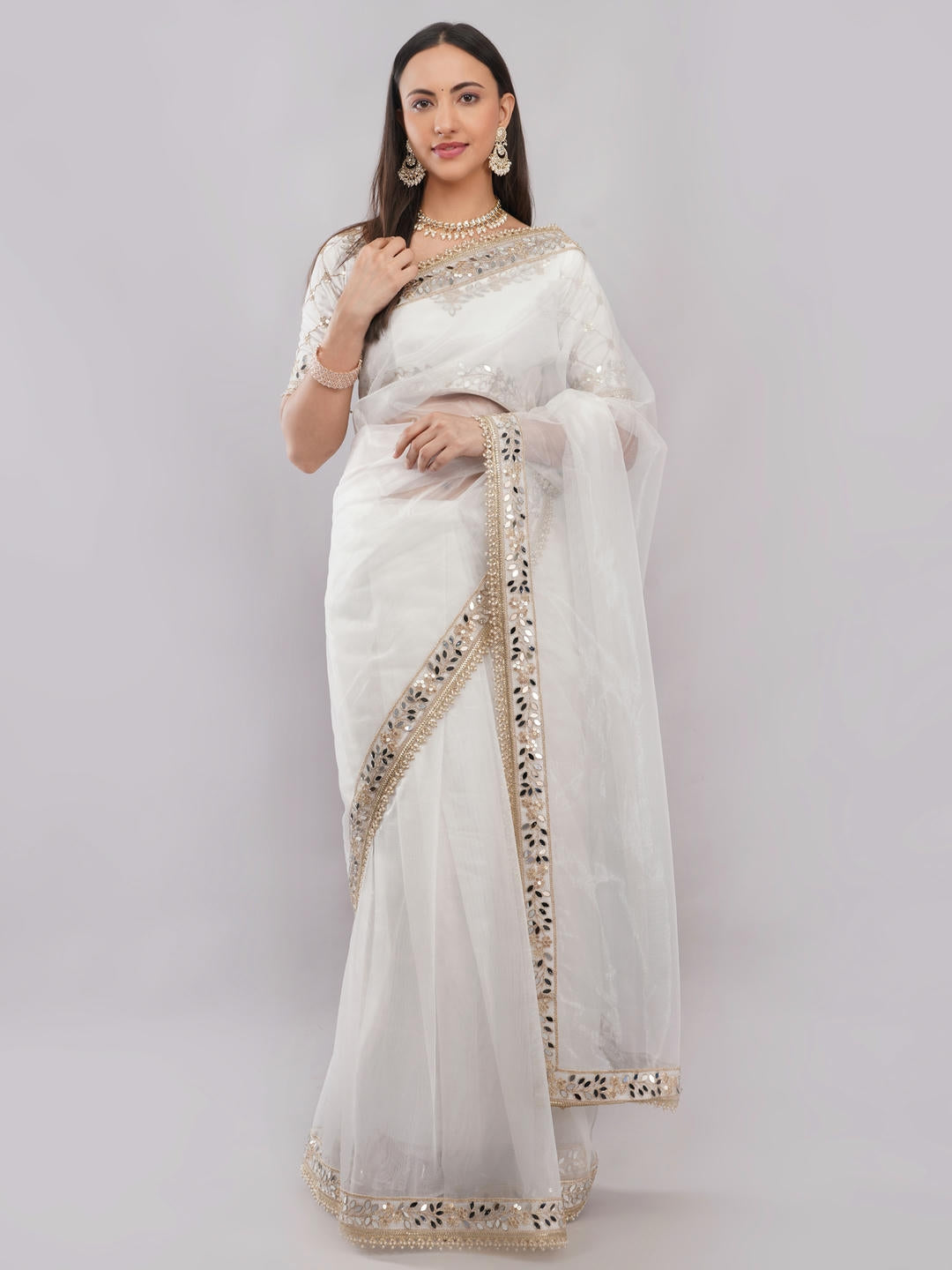 Beautiful woman styled in a classic white nettwill sheer saree featuring elegant tonal embroidery and a matching unstitched blouse by Samantha.