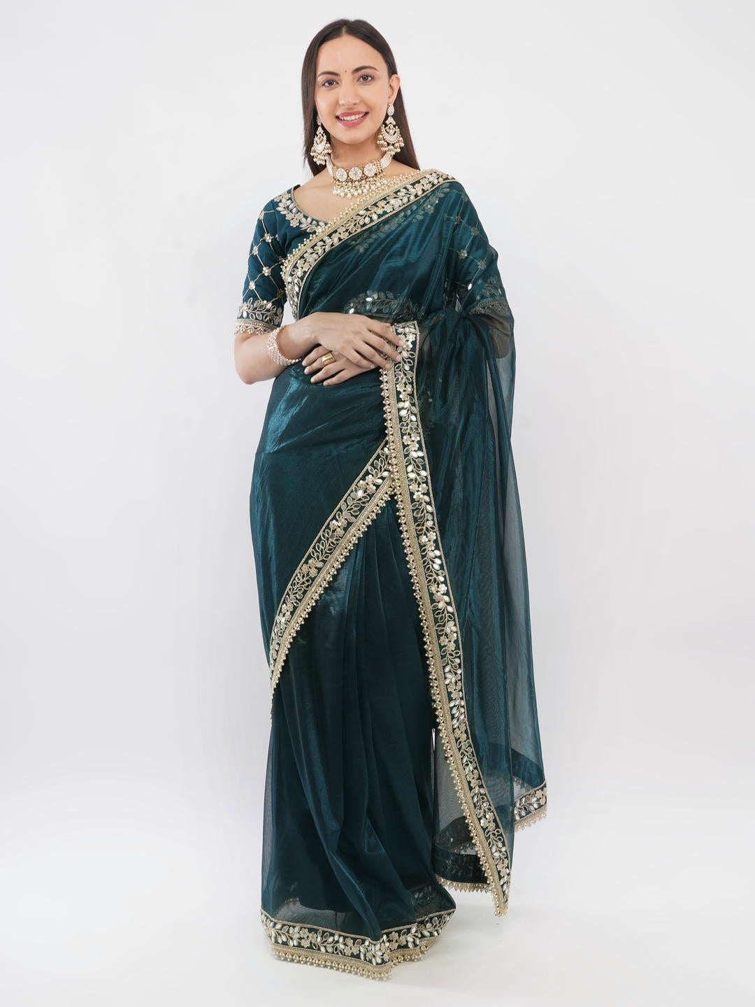 Beautiful woman styled in a classic blue nettwill sheer saree featuring elegant tonal embroidery and a matching unstitched blouse by Samantha.