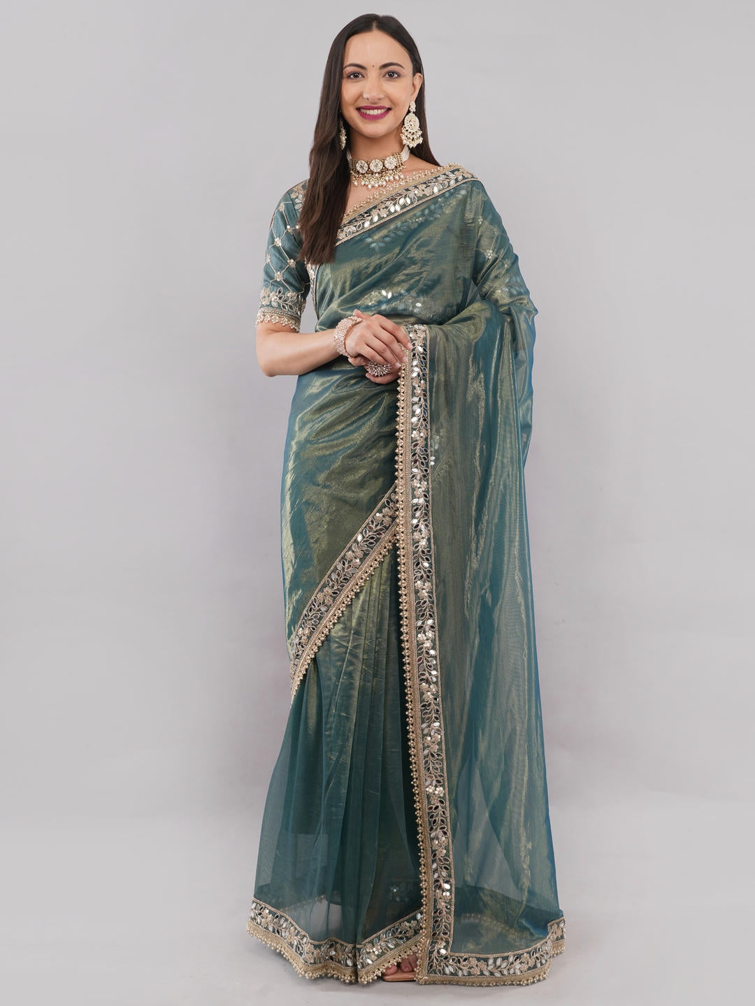 Beautiful woman styled in a classic metallic green nettwill sheer saree featuring elegant tonal embroidery and a matching unstitched blouse by Samantha.