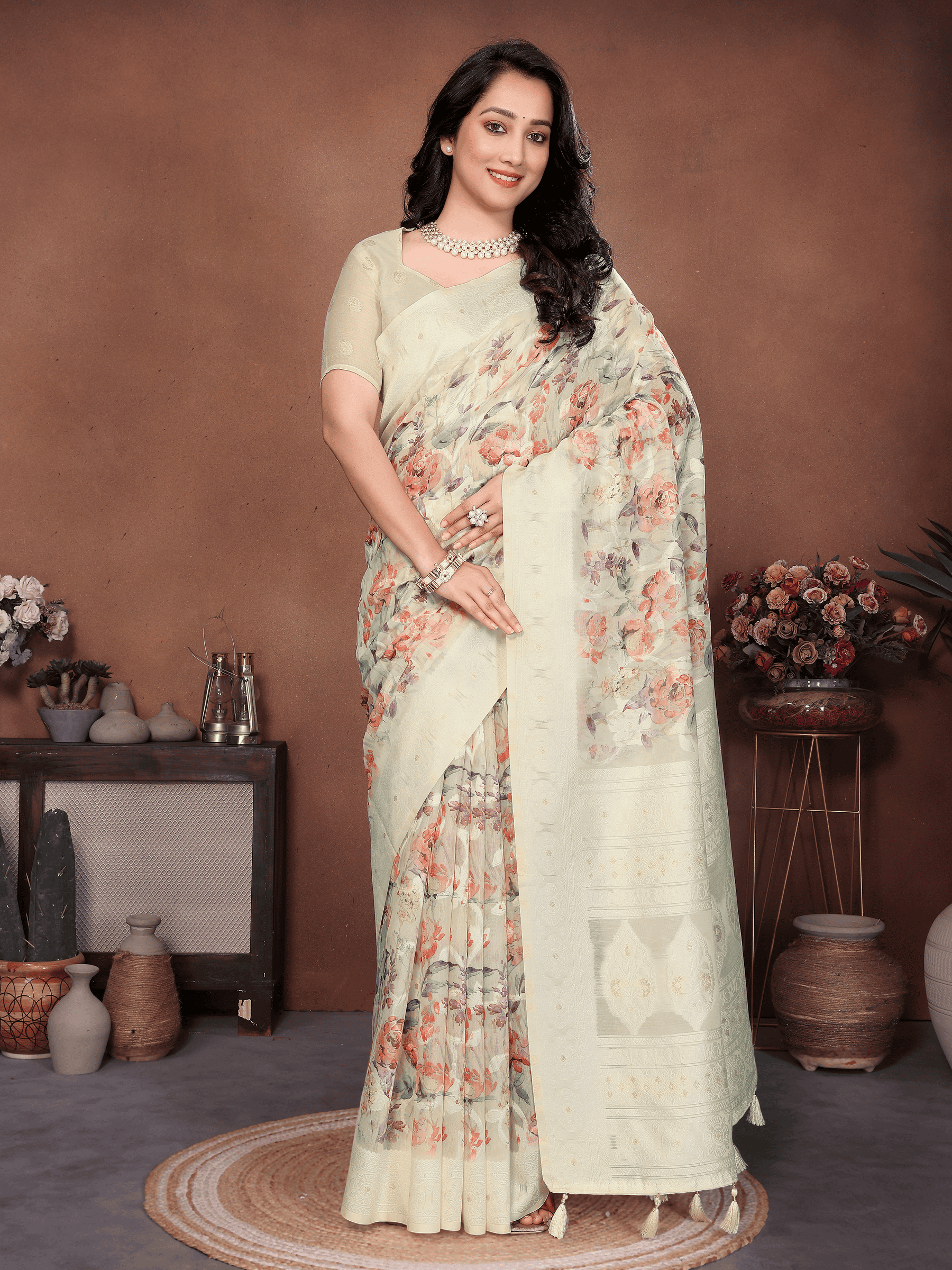 Beige semi-sheer floral print saree with champagne gold zari border and tassel pallu