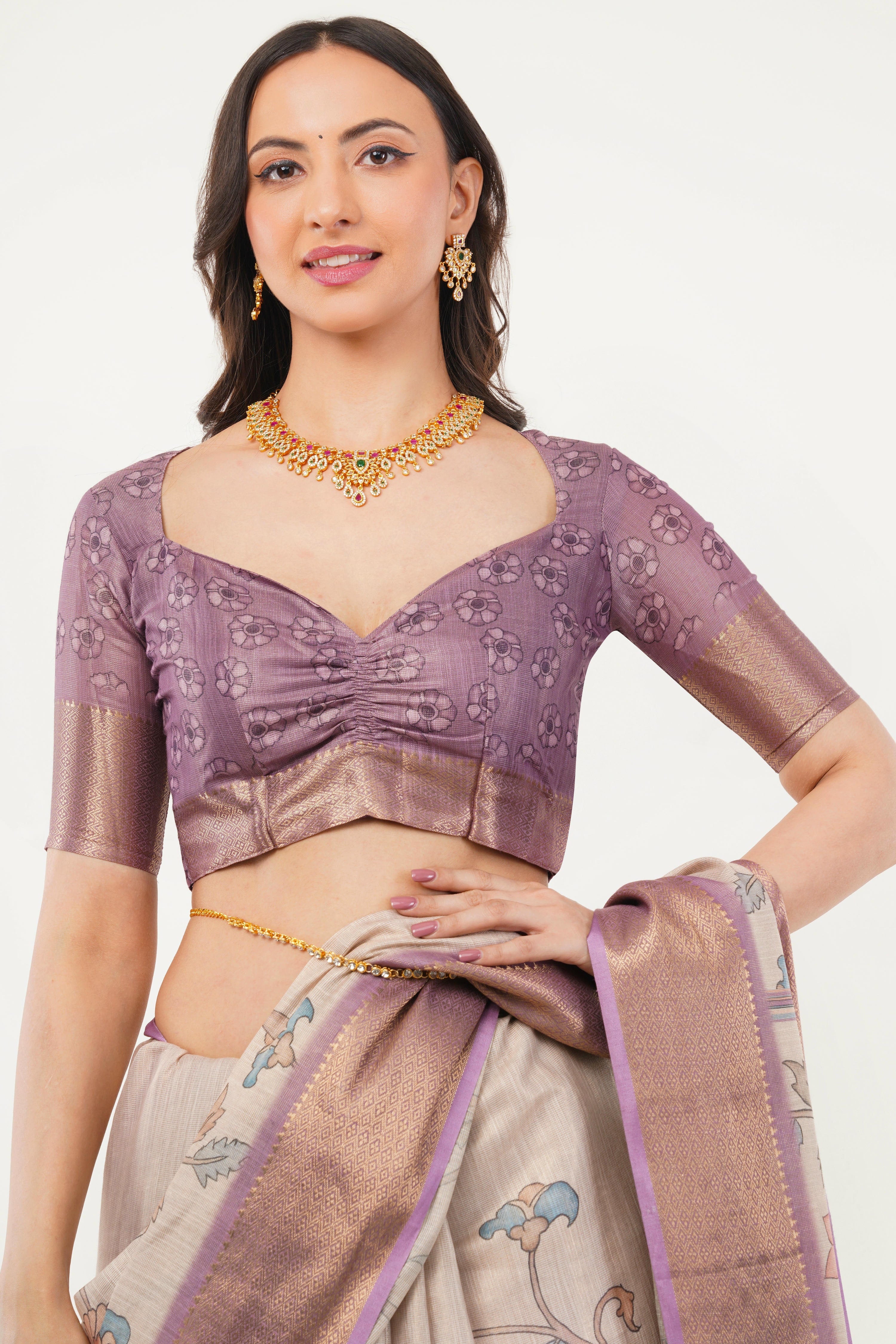 Cream kalamkari floral saree with rose gold zari border and mauve ruched blouse