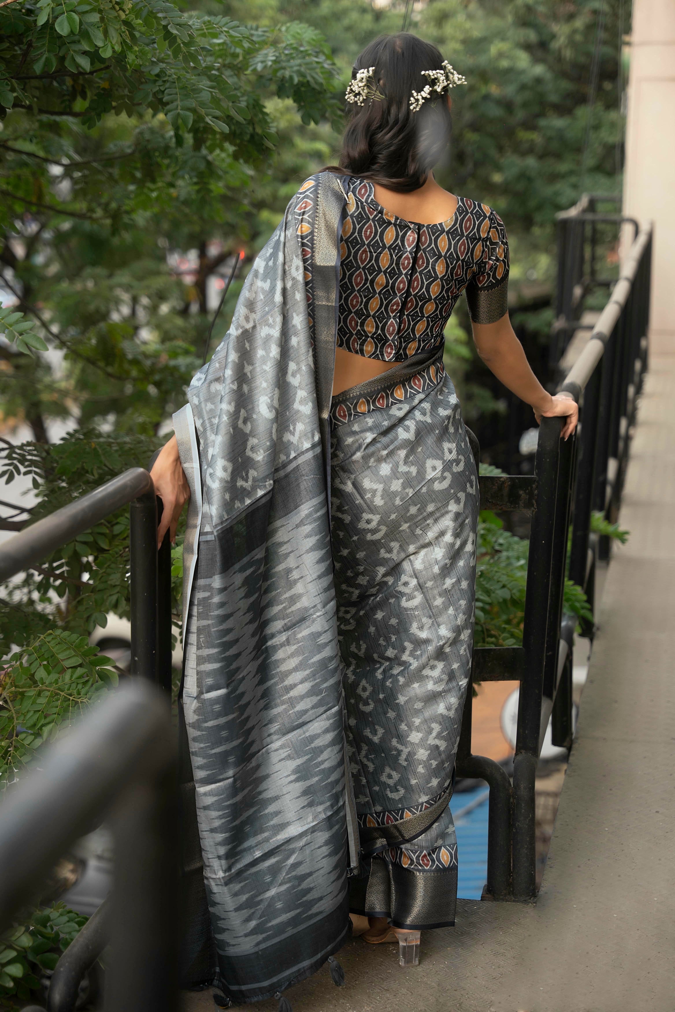 Grey and slate ikat print saree with antique gold zari border and coordinating blouse