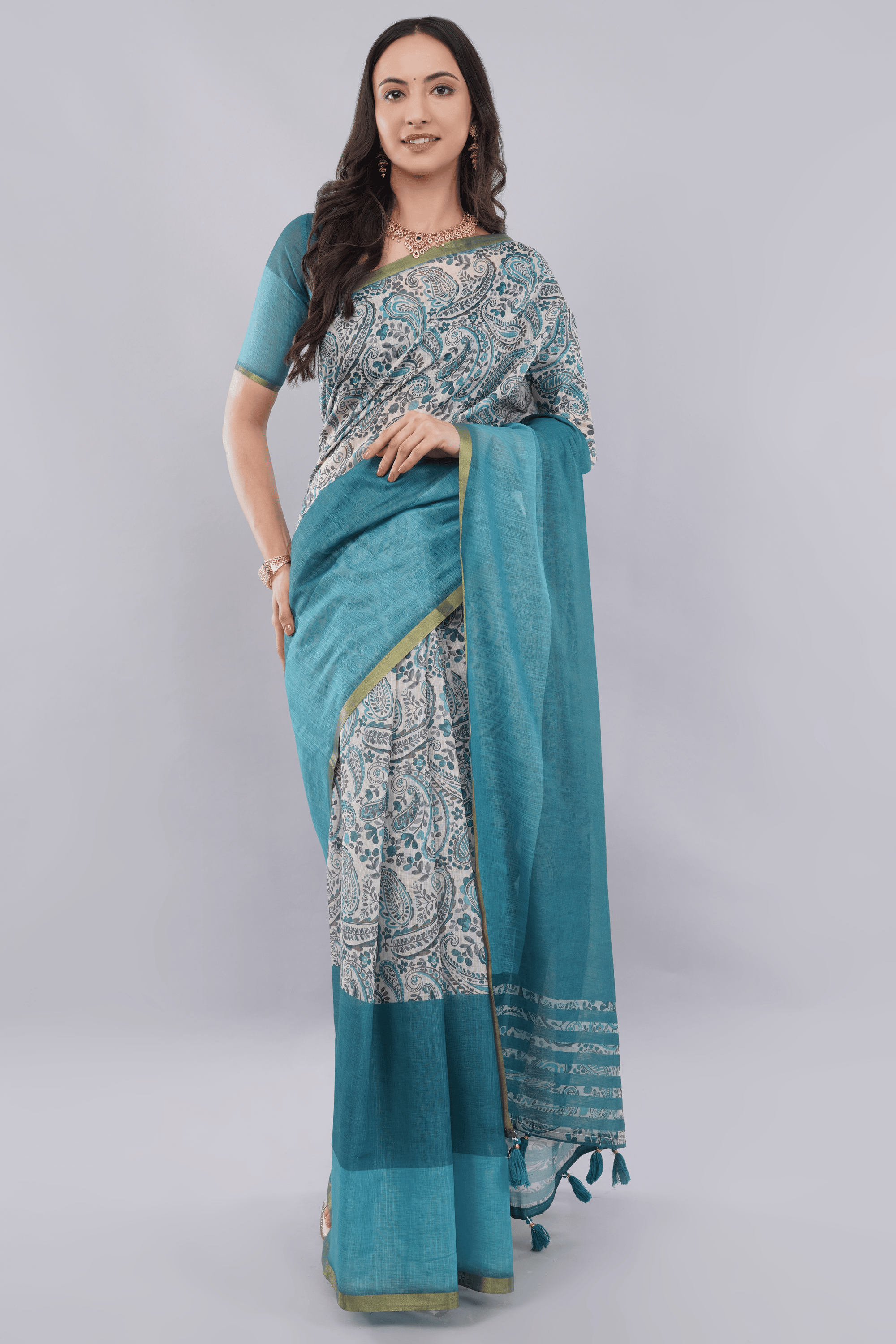 Off white teal paisley printed regular saree with zari border and tassel pallu by Samantha