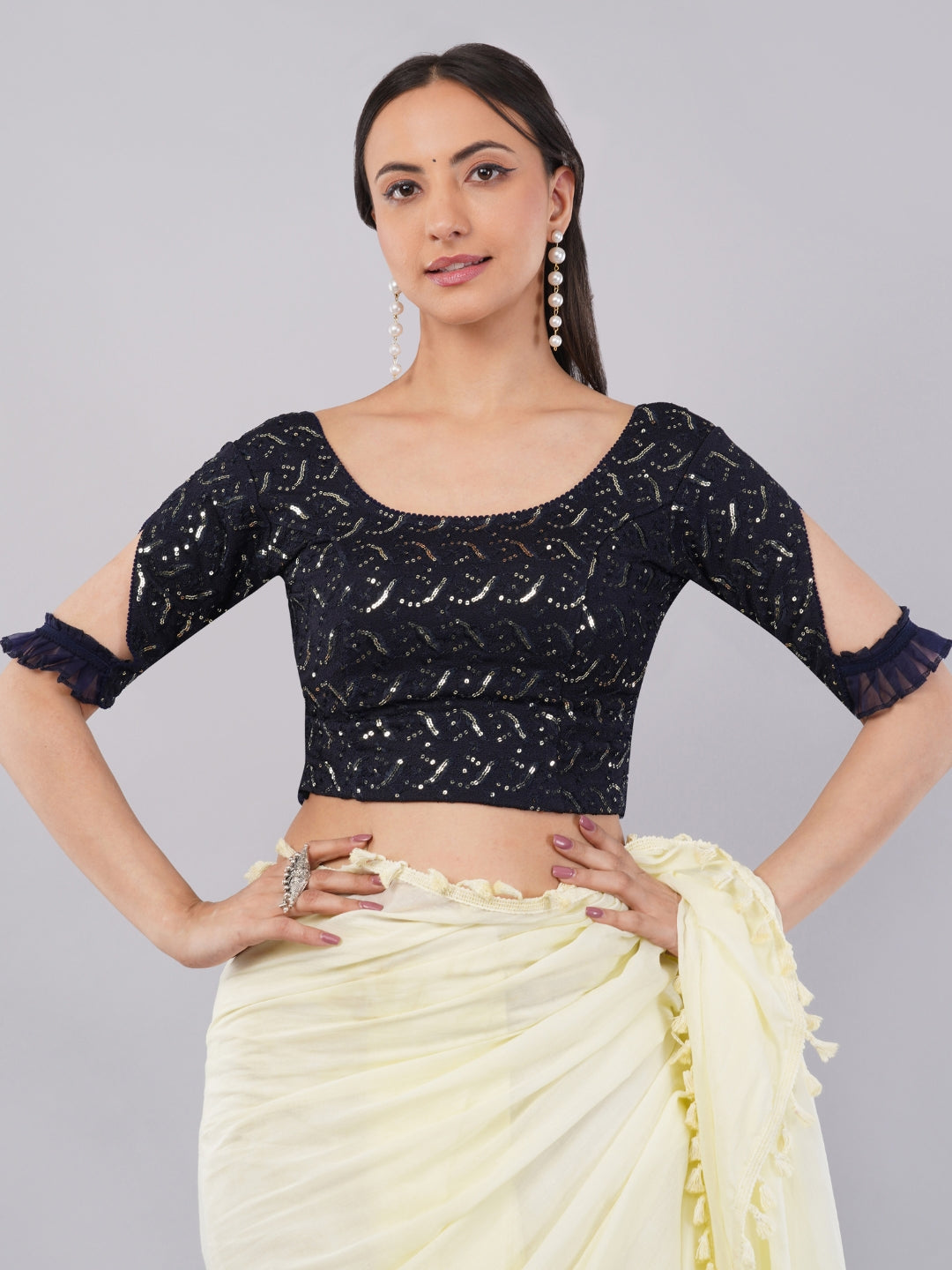 Woman wearing dark blue sequin lycra blouse with slit ruffle sleeves