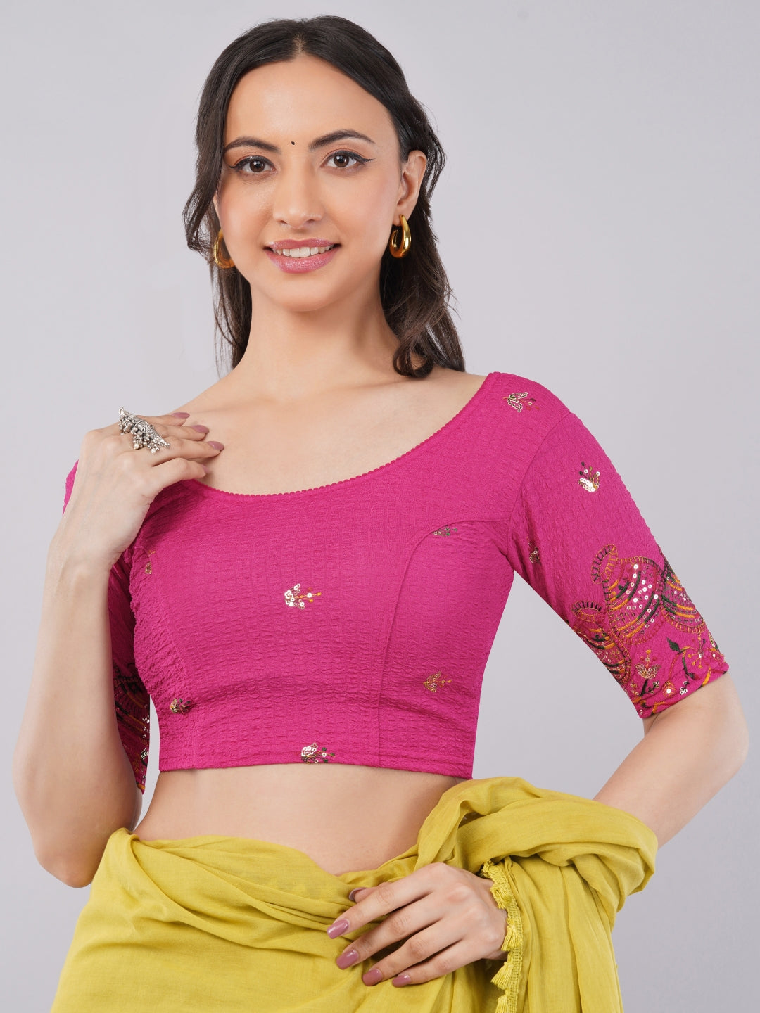 Woman wearing hot pink lycra blouse with traditional embroidered sleeves