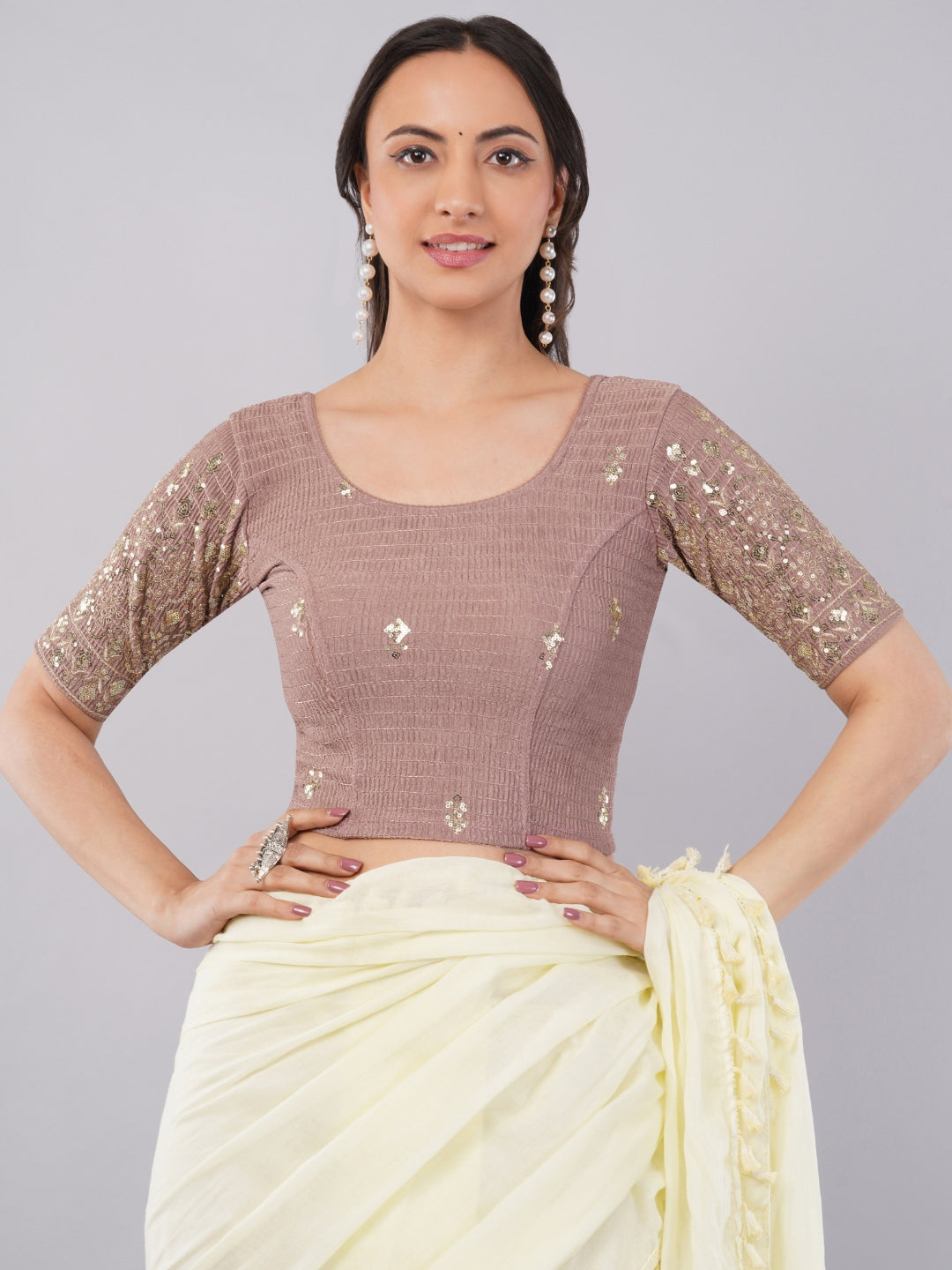 Woman wearing dusty mauve lycra blouse with gold sequin embroidered sleeves