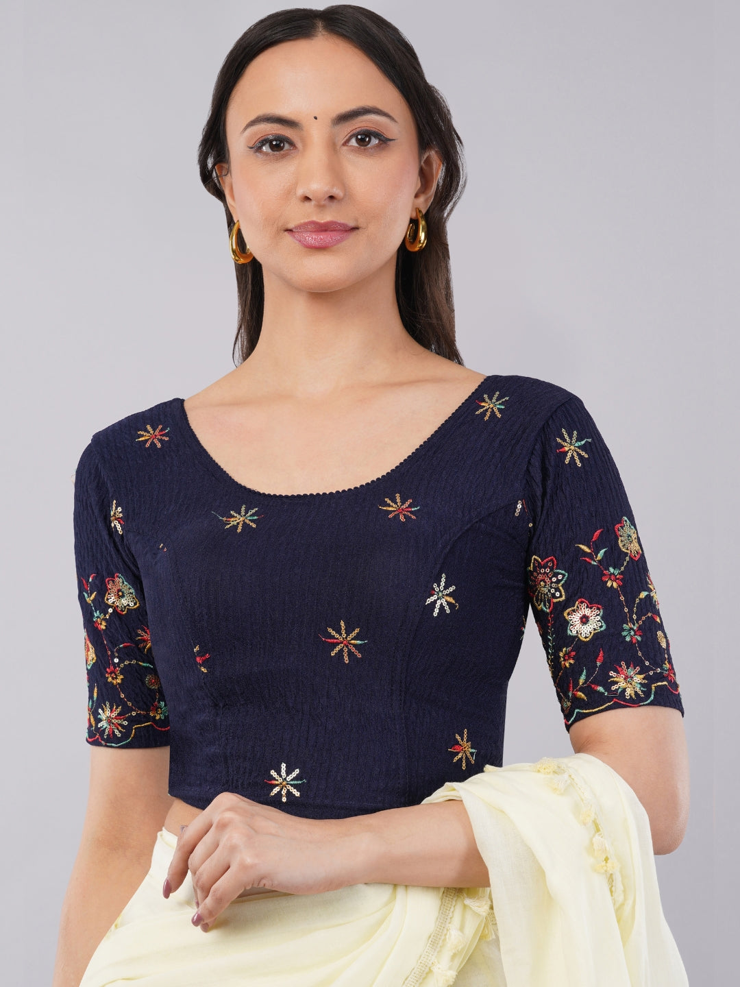 Woman wearing maastricht blue lycra blouse with heavy floral embroidered sleeves