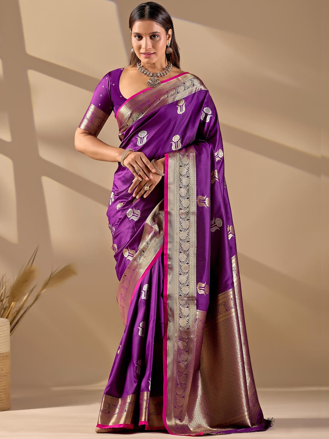 Beautiful woman styled in a purple woven design silk saree featuring a heavy zari border and solid blouse by Samantha.