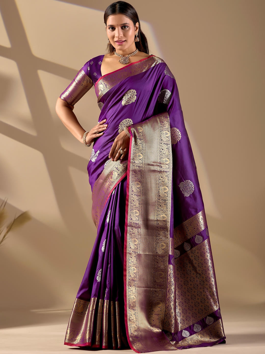 Beautiful woman styled in a purple woven design silk saree featuring a heavy zari border and solid blouse by Samantha.