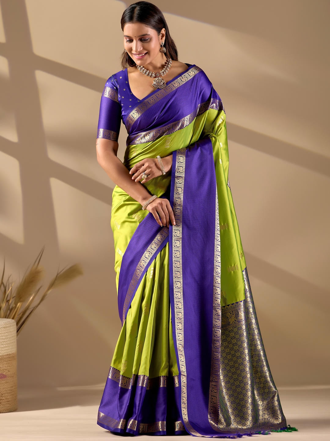 Beautiful woman styled in a lemon green woven design silk saree featuring a heavy zari border and solid blouse by Samantha.
