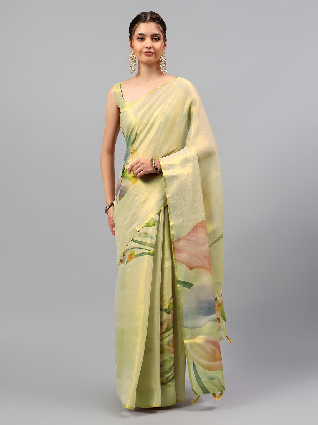 Beautiful woman styled in a beige gold art tissue silk saree with intricate embroidery and solid zari border by Samantha.