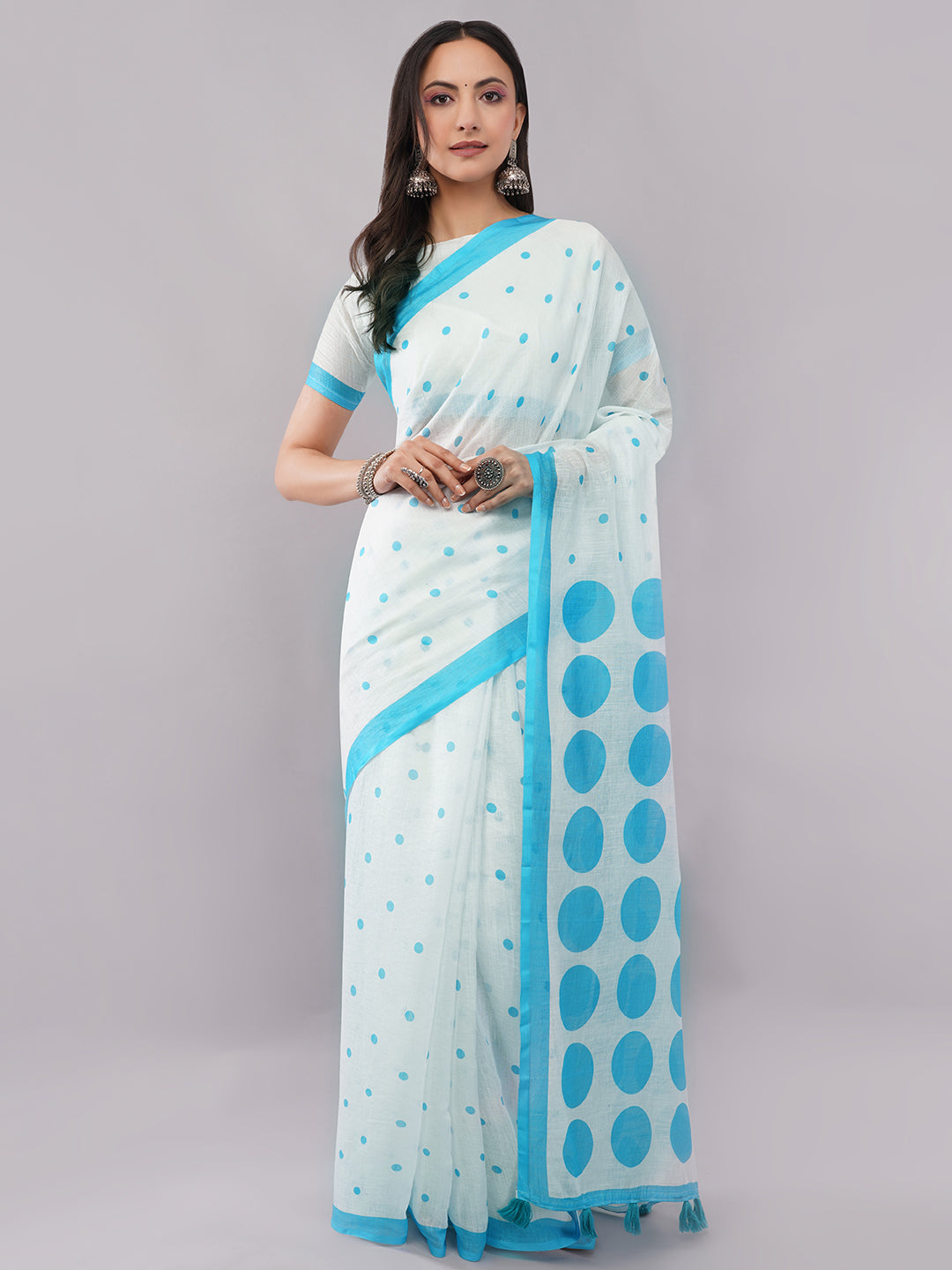White linen saree with sky blue polka dots and geometric pallu draped by woman for summer wear by Samantha