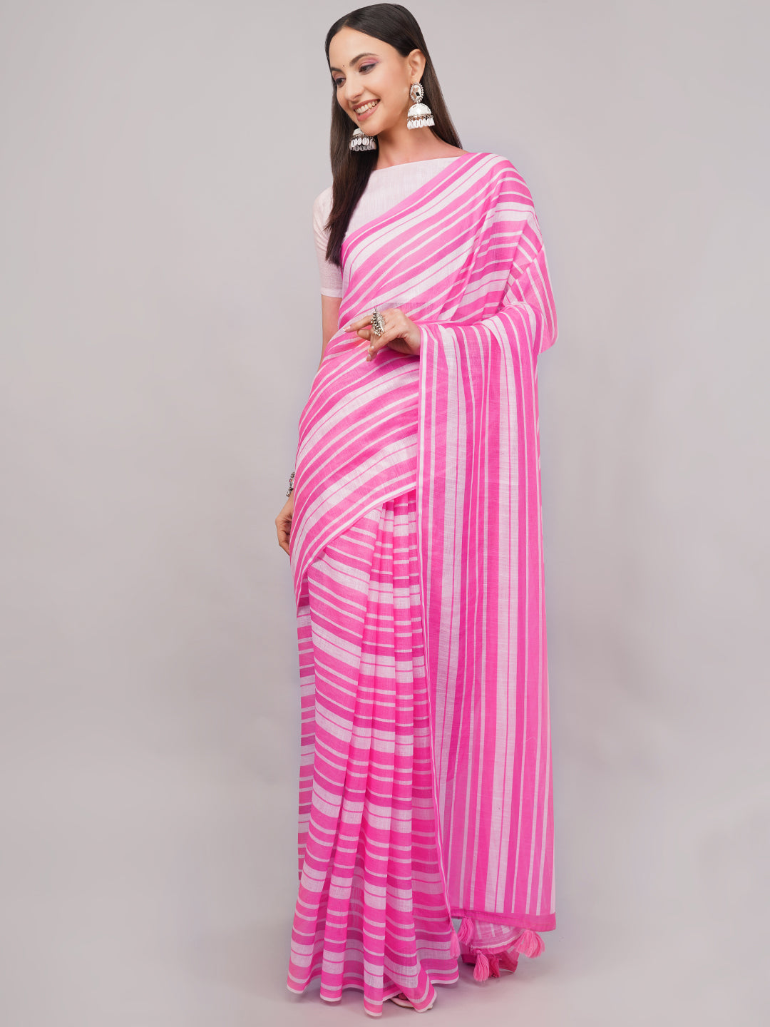Pink and white leheriya striped linen saree draped by woman for summer wear by Samantha