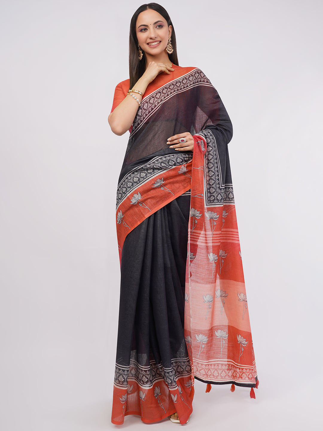 Black linen saree with rust red floral border and pallu draped by woman for office wear by Samantha