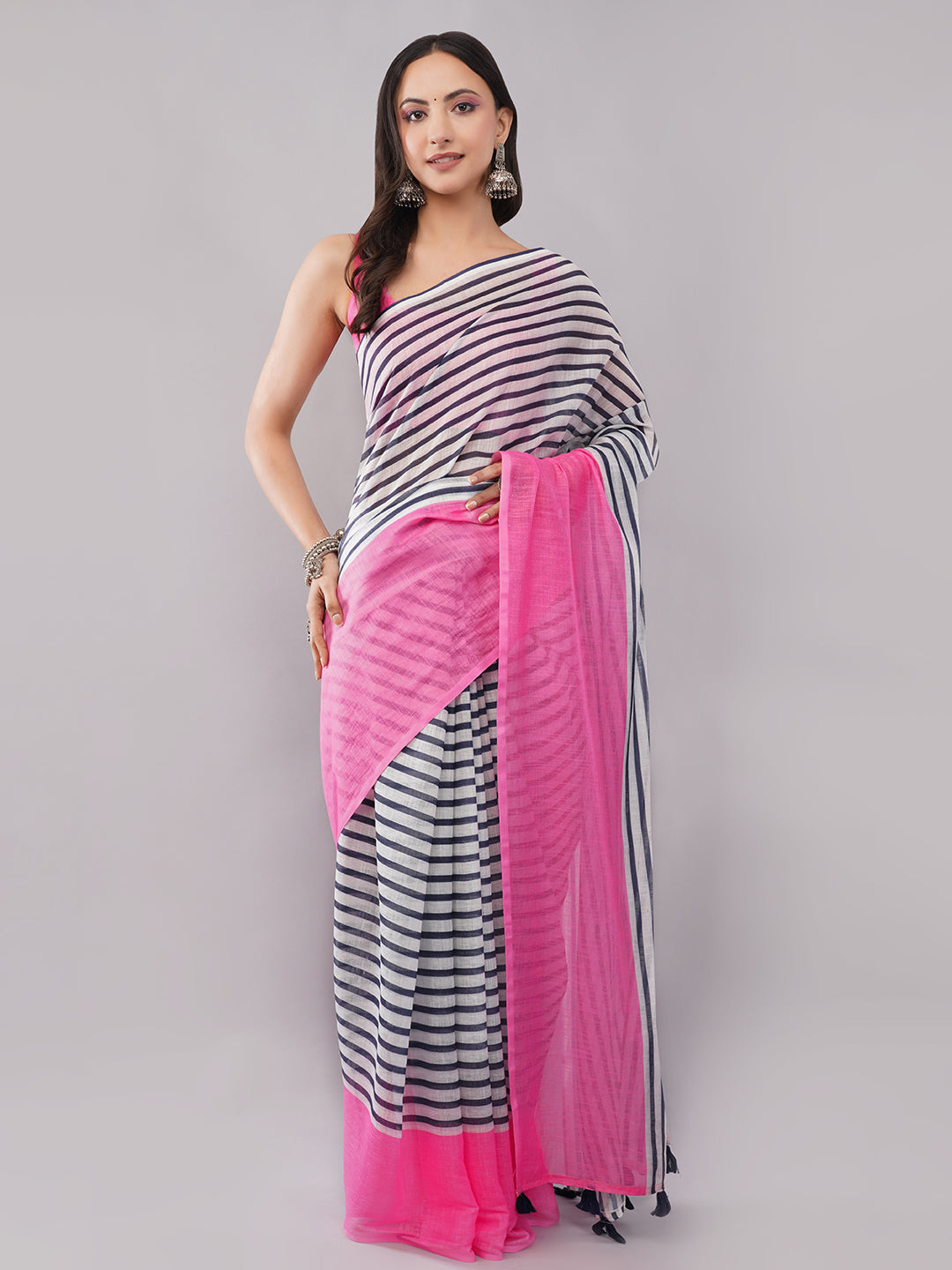White and navy striped linen saree with hot pink border draped by woman for modern office wear by Samantha
