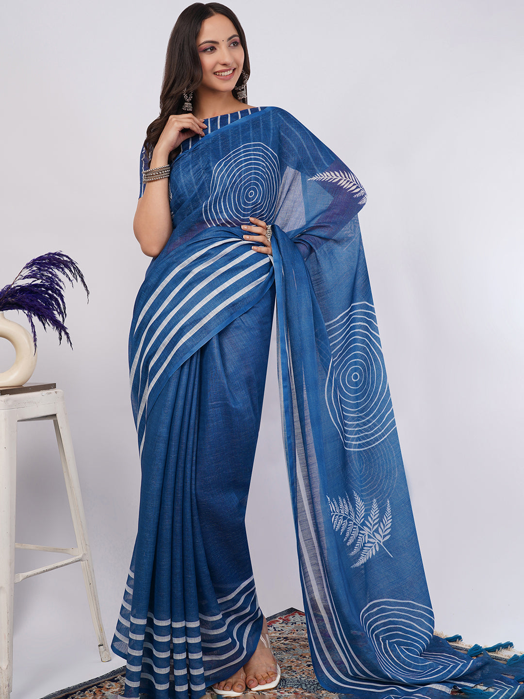 Indigo blue linen saree with white spiral and leaf print draped by woman for artistic office wear by Samantha
