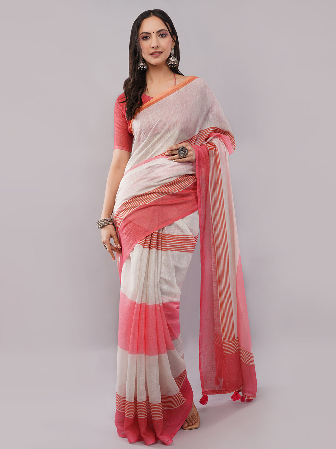 White linen saree with red striped border draped by woman for office wear by Samantha