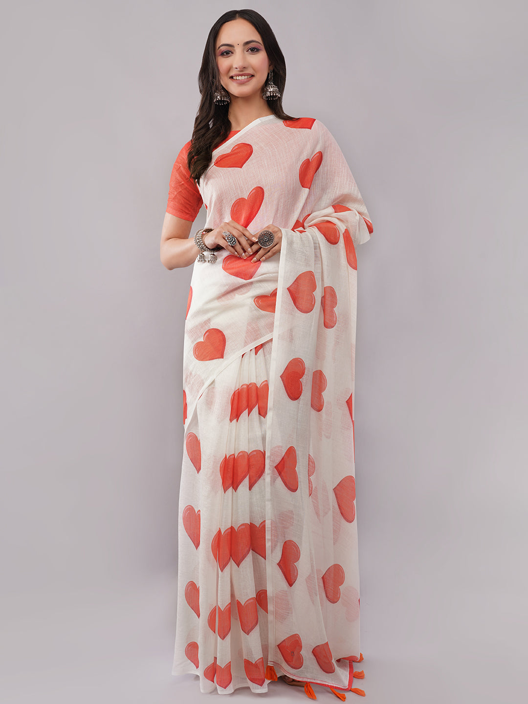 White linen saree with red heart print draped by woman for romantic wear by Samantha