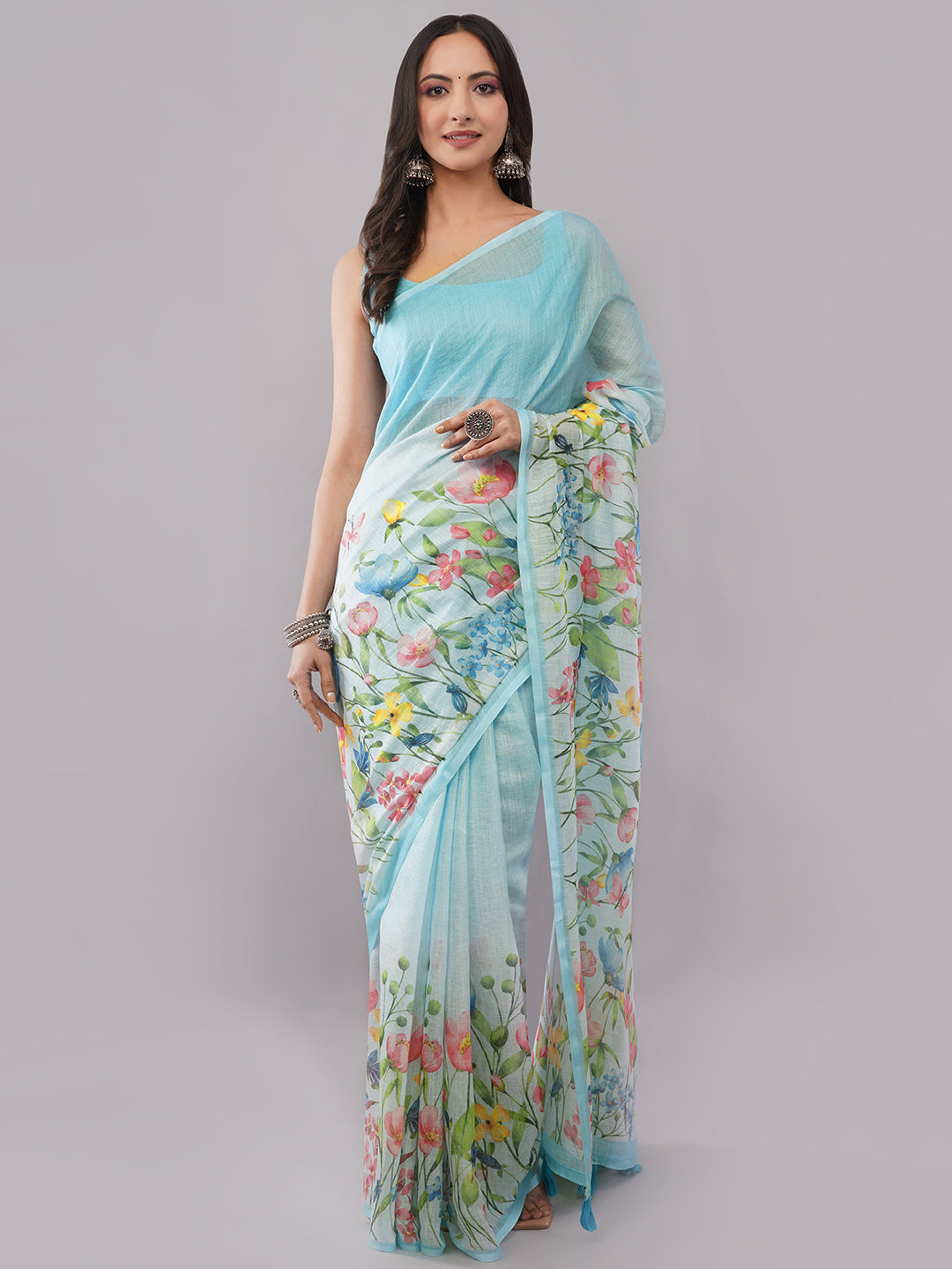 Sky blue linen saree with multicolor floral print draped by woman for summer wear by Samantha