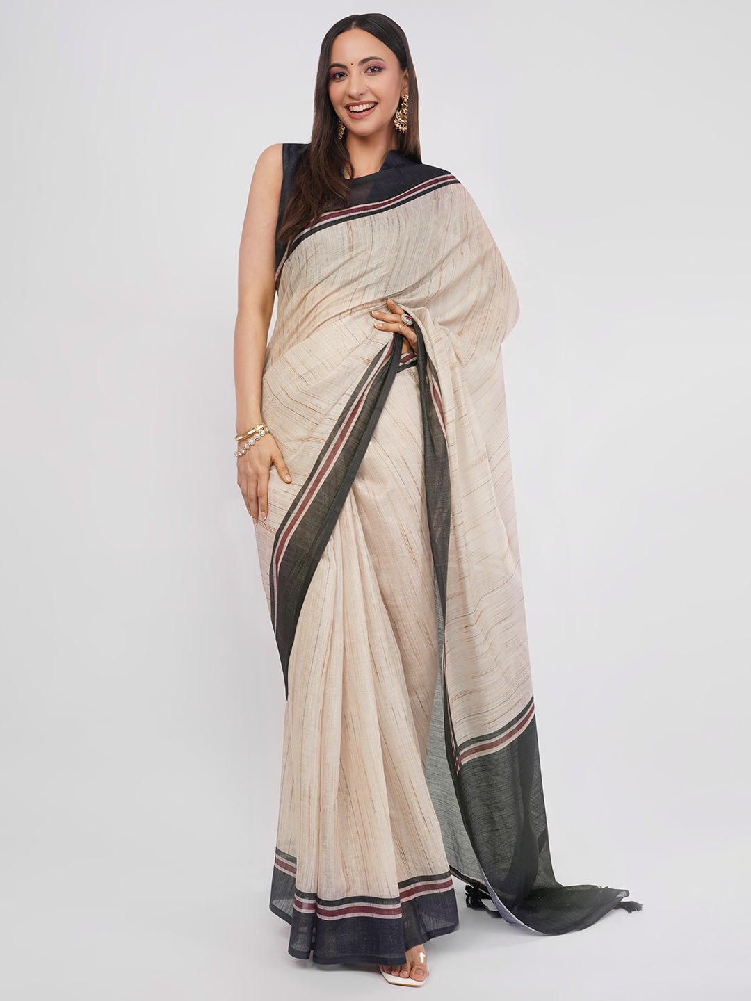 Beige and black pinstriped linen saree with solid black blouse draped by woman for corporate wear by Samantha