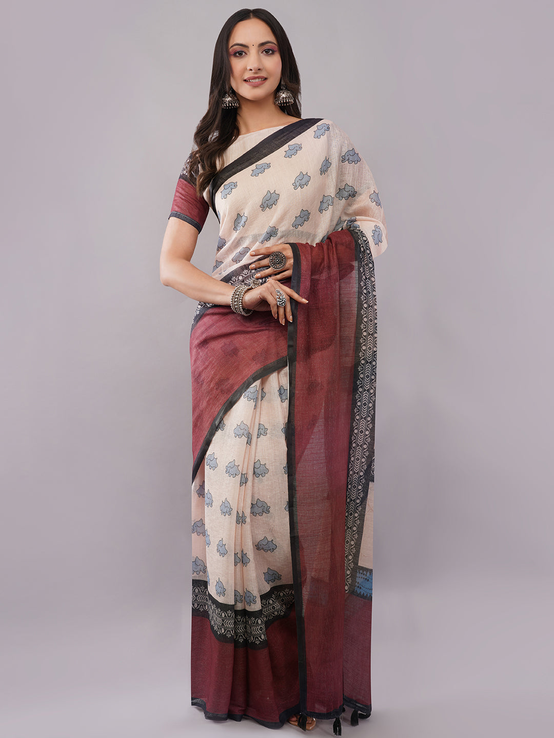 Cream and maroon linen saree with elephant print draped by woman for quirky office wear by Samantha