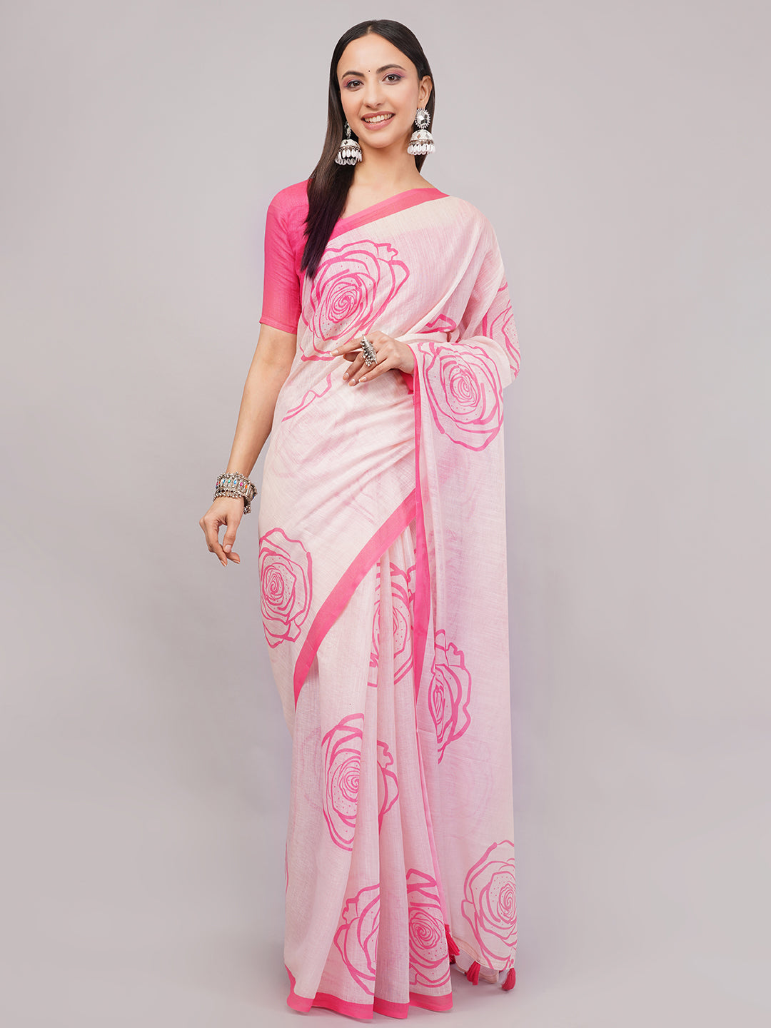 Peach pink linen saree with hot pink rose outline print draped by woman for romantic summer wear by Samantha