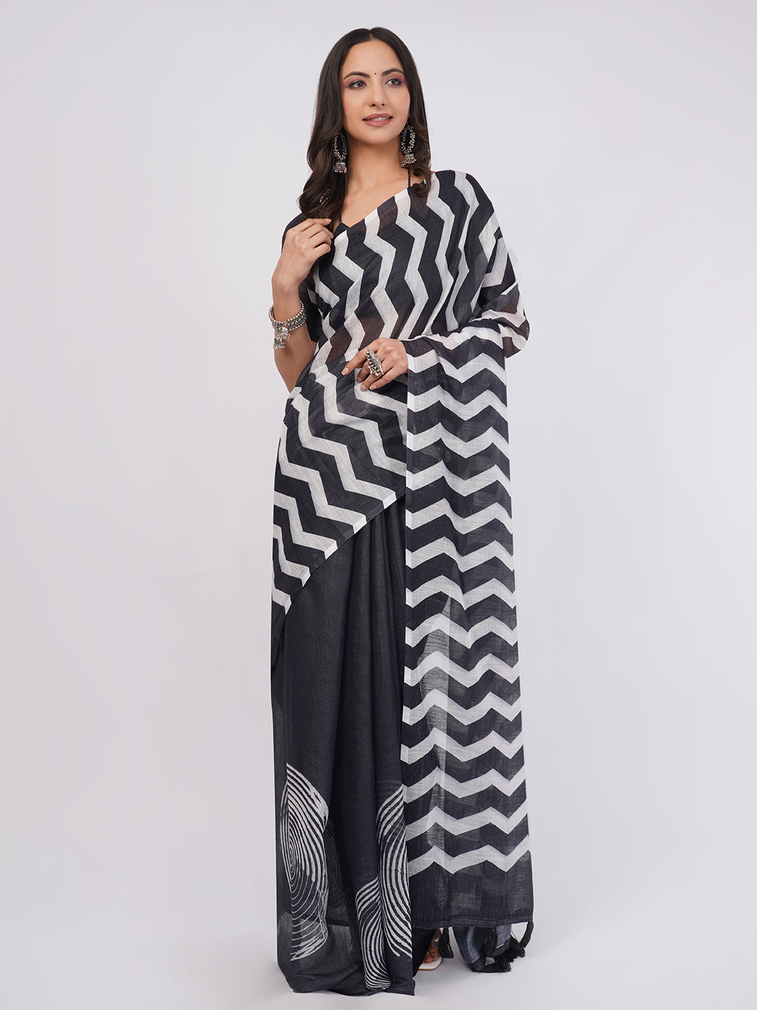 Black and white zigzag chevron and spiral print linen saree draped by woman for modern geometric wear by Samantha