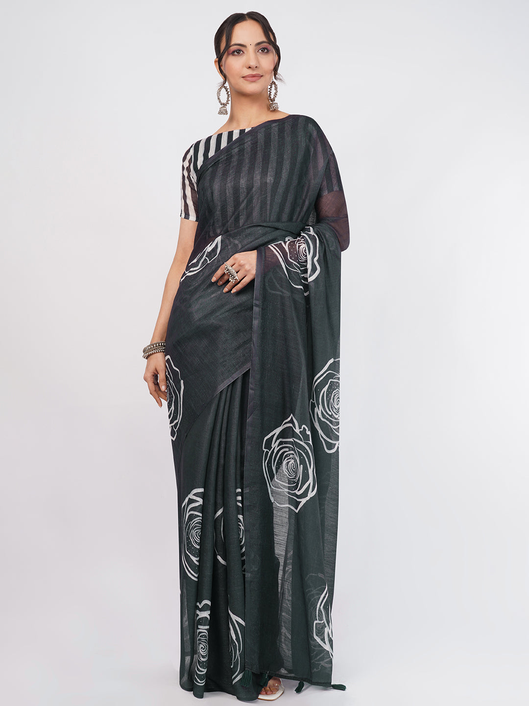 Black linen saree with white rose outline print and striped blouse draped by woman for elegant wear by Samantha
