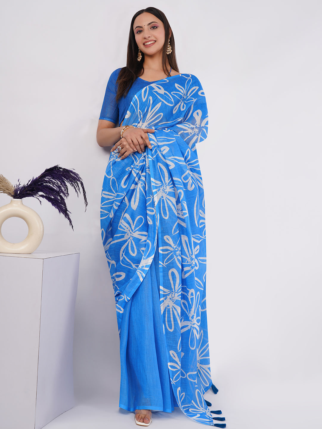 Sky blue linen saree with white sketch floral print draped by woman for summer wear by Samantha