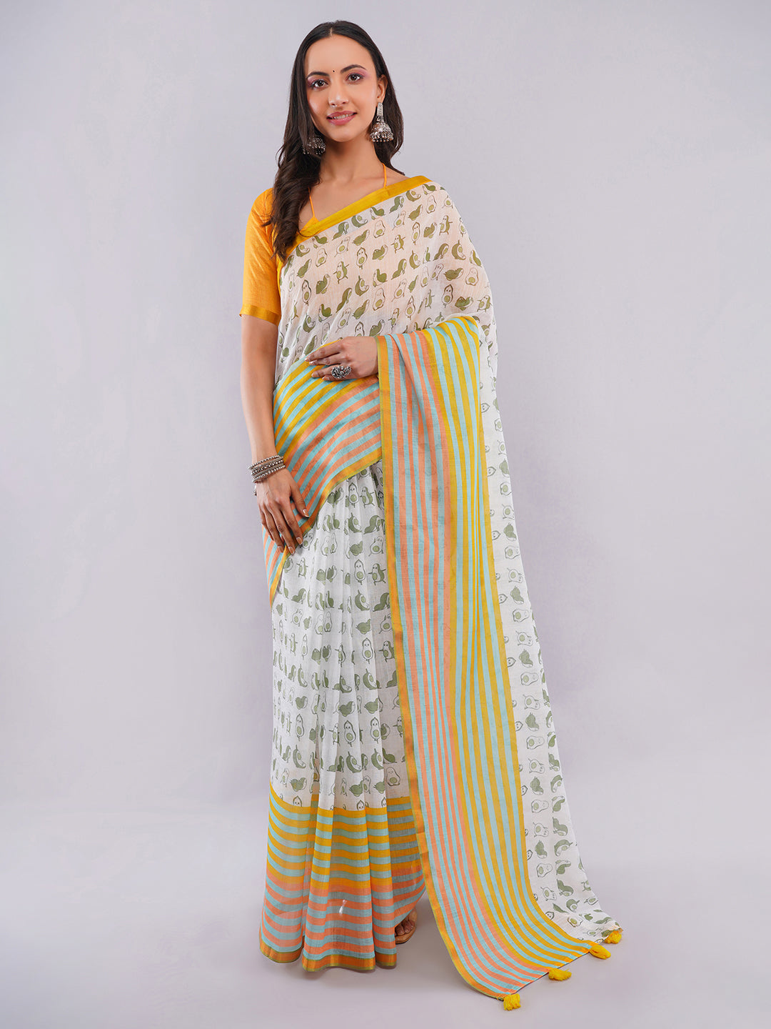 White linen saree with quirky avocado and penguin prints and green-orange striped border draped by woman for funky wear by Samantha