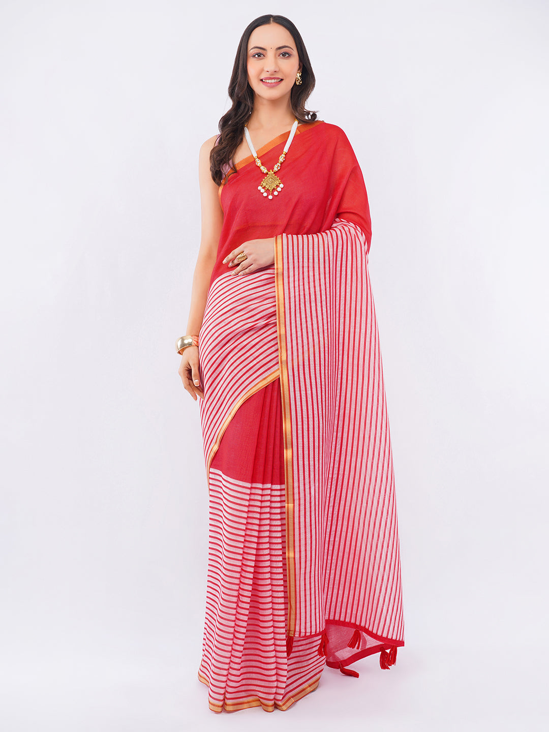 Crimson red and white striped linen saree with gold zari border draped by woman for modern ethnic wear by Samantha