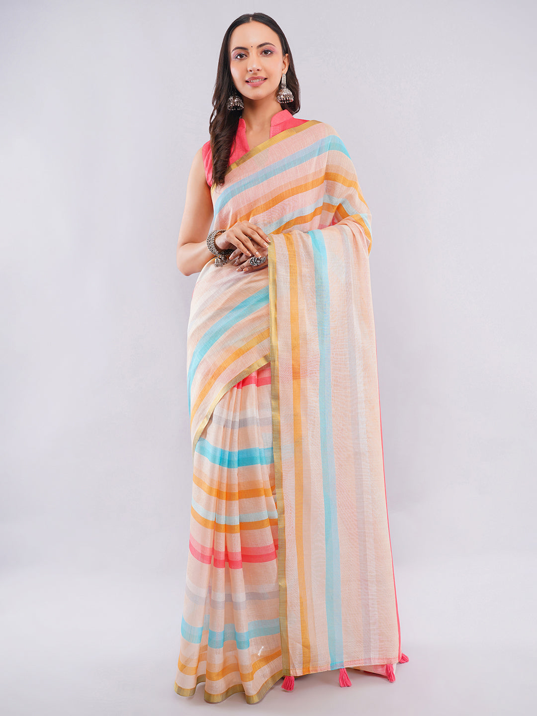 Multicolor pastel striped linen saree with gold zari border draped by woman for summer day wear by Samantha