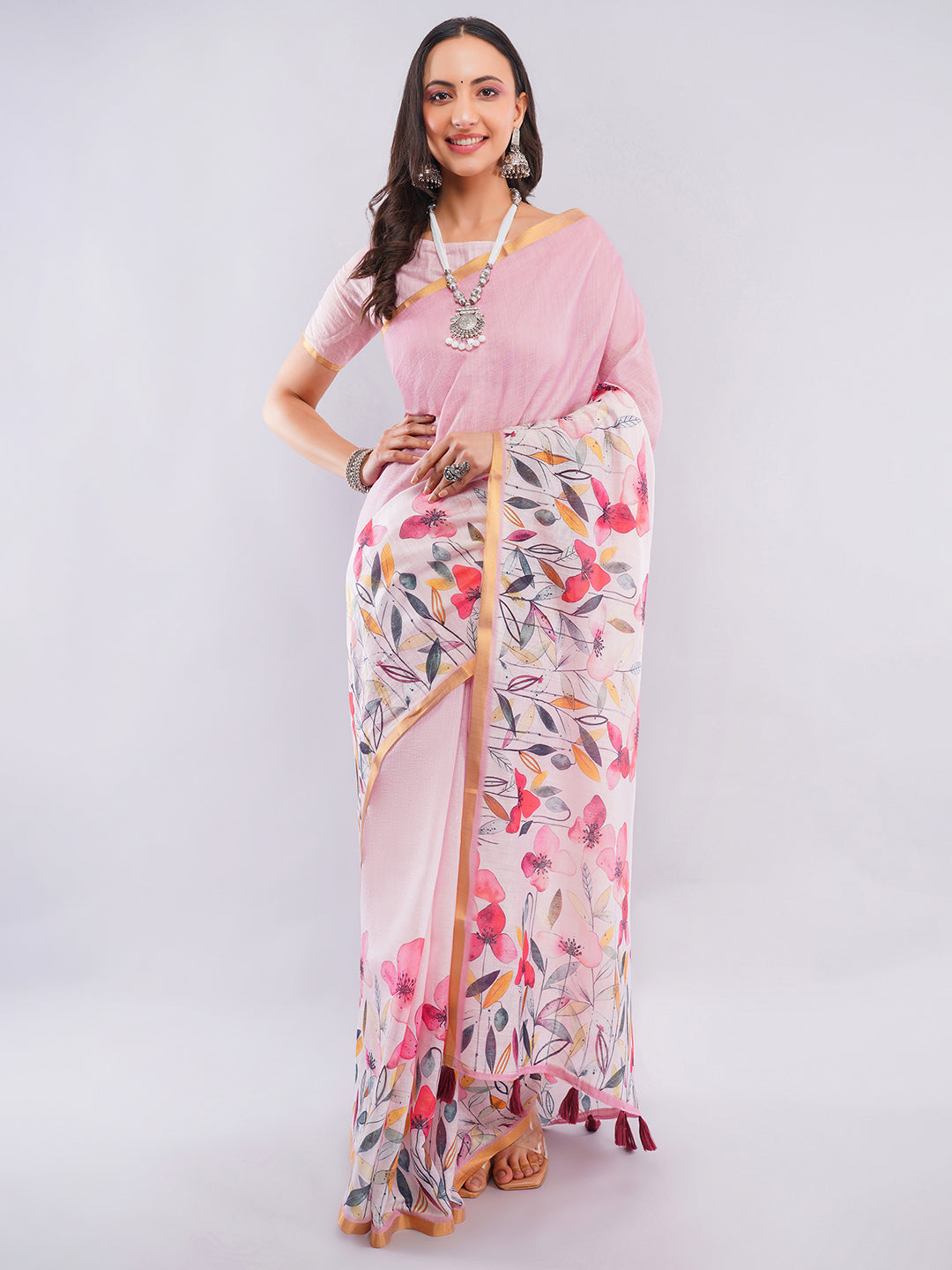 Baby pink linen saree with multicolor wildflower floral prints and zari border draped by woman for summer wear by Samantha