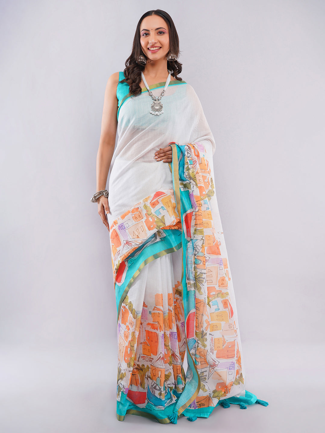 Off-white linen saree with Mediterranean cityscape print and turquoise blouse draped by woman for vacation wear by Samantha