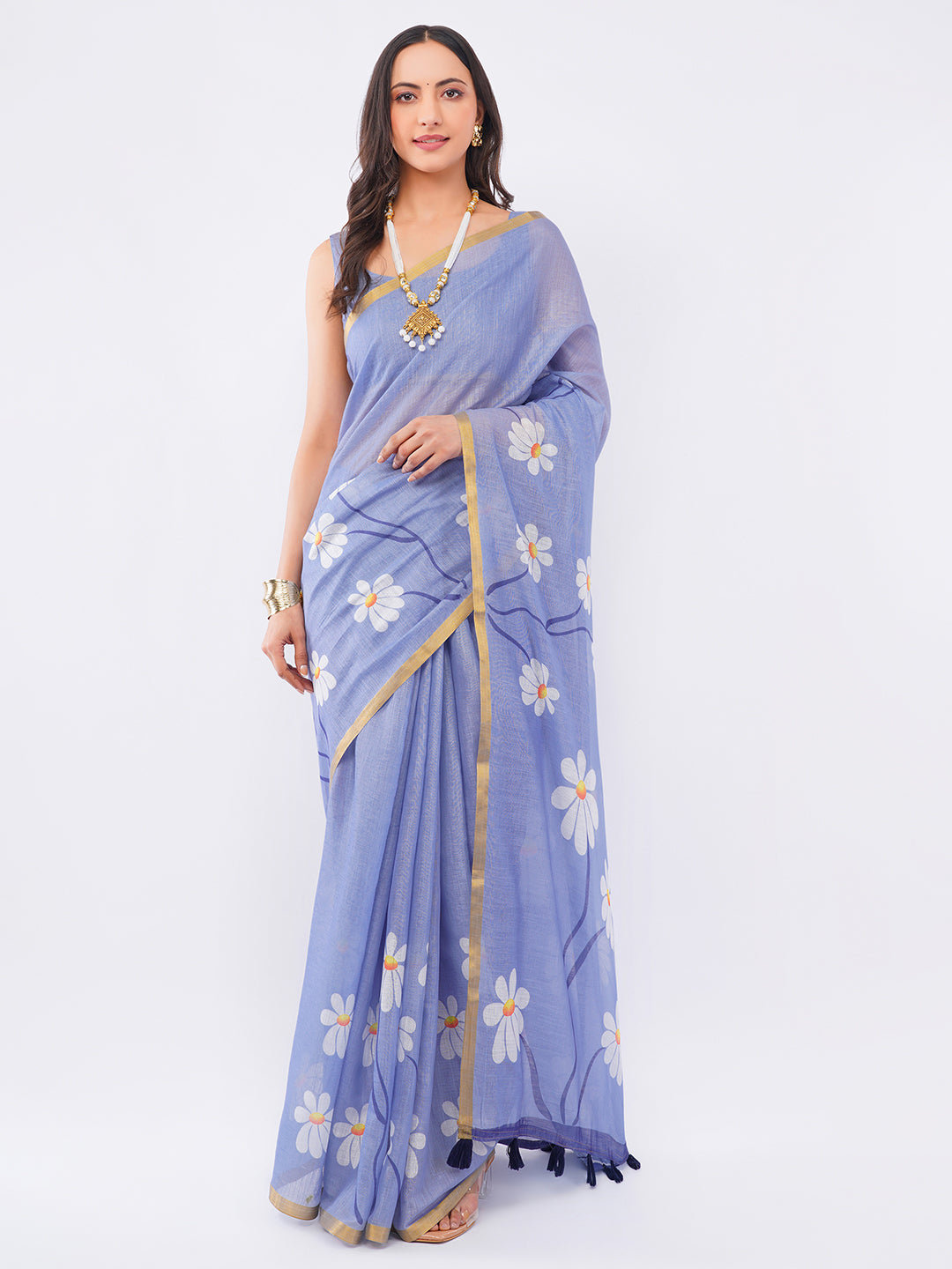Violet lavender linen saree with white daisy floral prints and gold zari border draped by woman for summer wear by Samantha