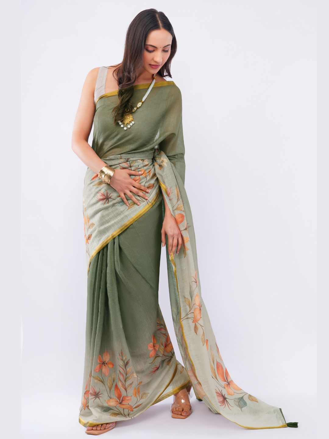 Dusty moss green linen saree with autumnal floral print and off-white blouse draped by woman for artsy office wear by Samantha