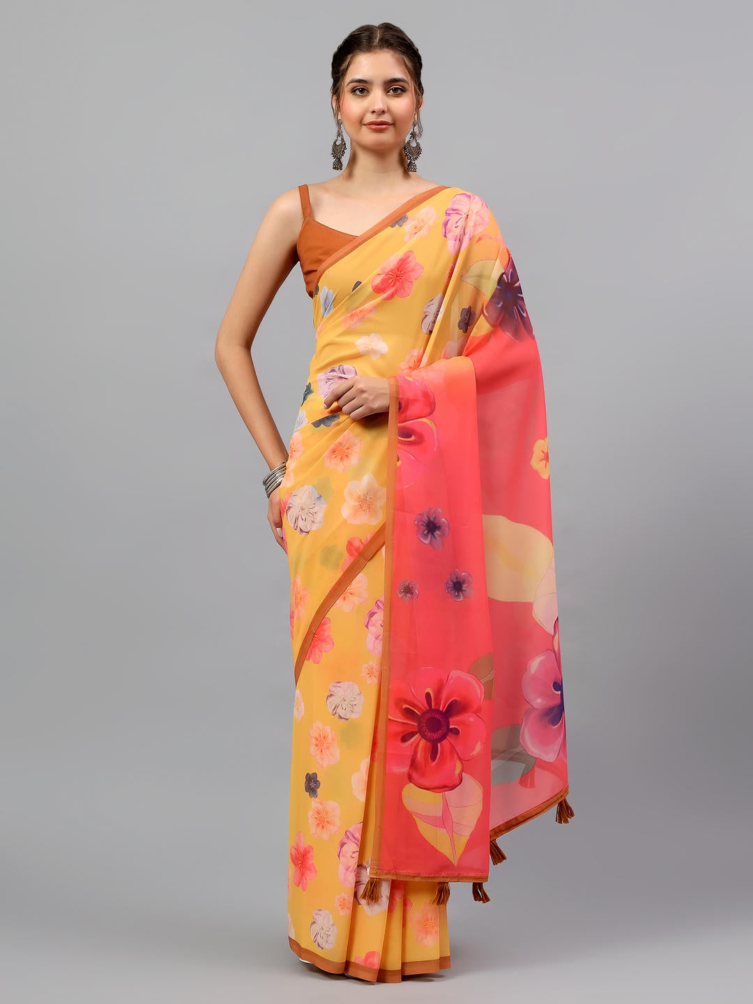 Beautiful woman styled in an amber yellow faux georgette saree with ethnic geometric prints by Samantha.