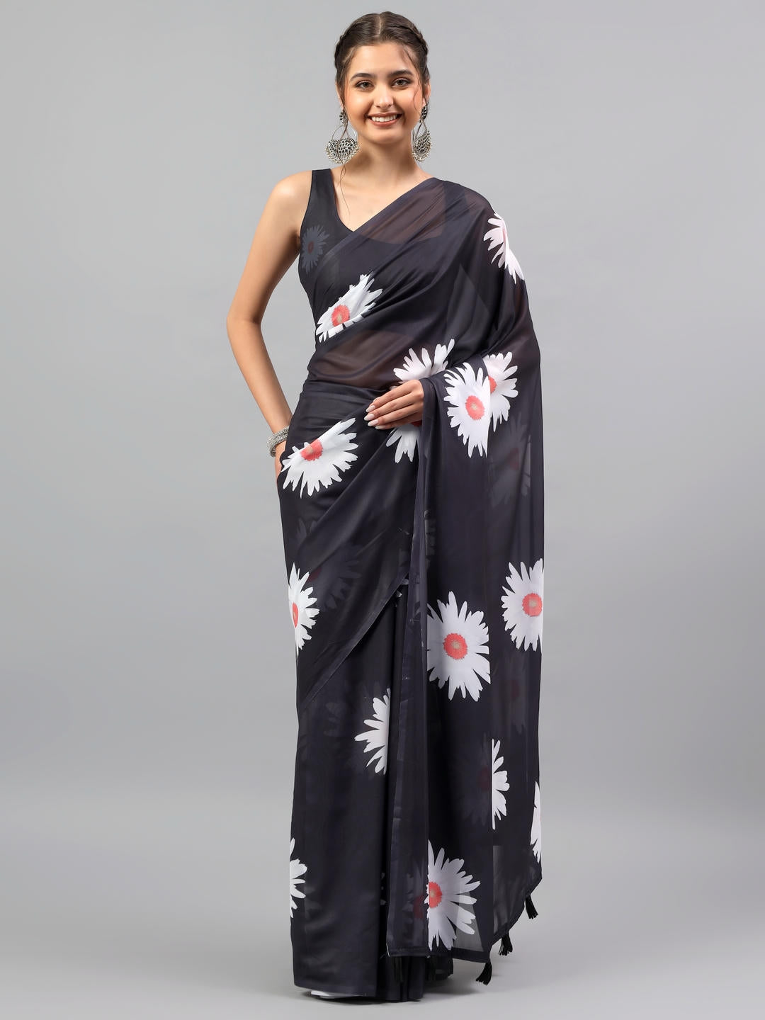 Beautiful woman styled in a bold black faux georgette saree with ethnic geometric prints by Samantha.
