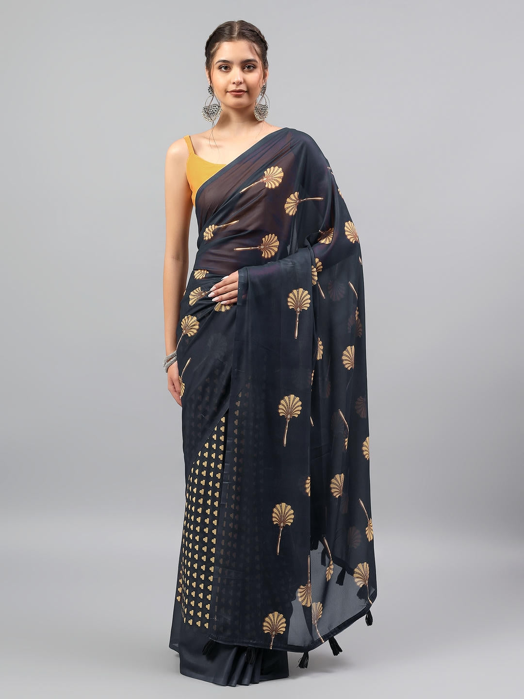 Beautiful woman styled in a midnight black faux georgette saree with botanical floral prints by Samantha.