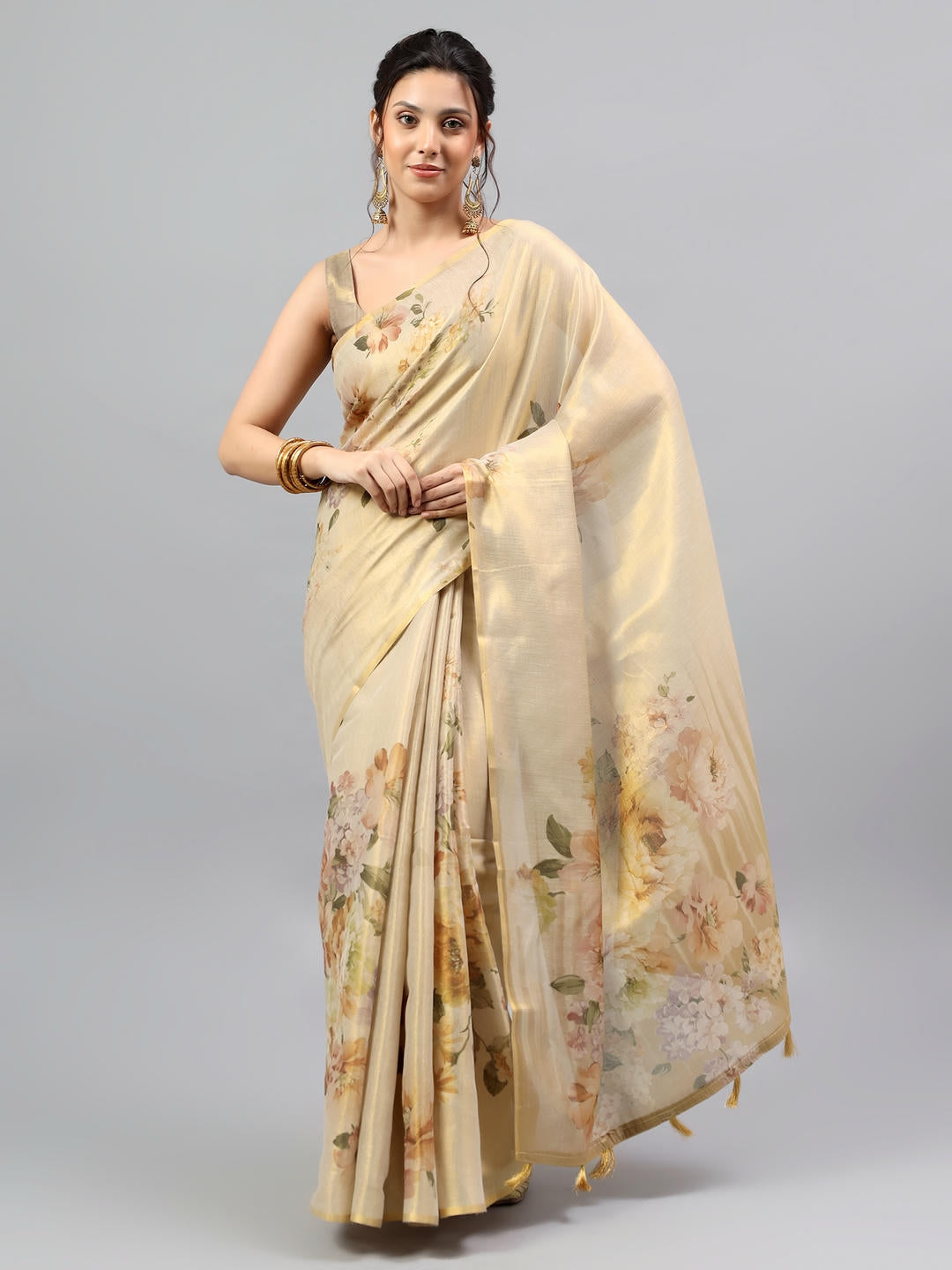 Beautiful woman styled in a majestic champagne beige heavy zari woven silk saree with a contrast pink blouse by Samantha.