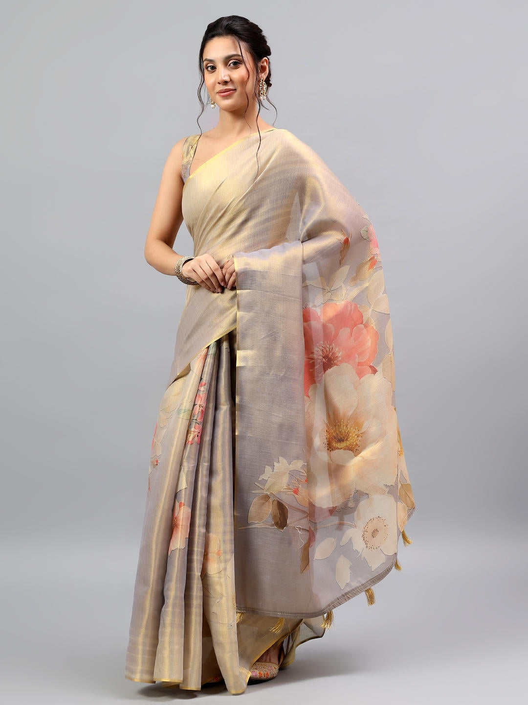 Beautiful woman styled in a majestic beige grey heavy zari woven silk saree with a deep peacock teal contrast blouse by Samantha.