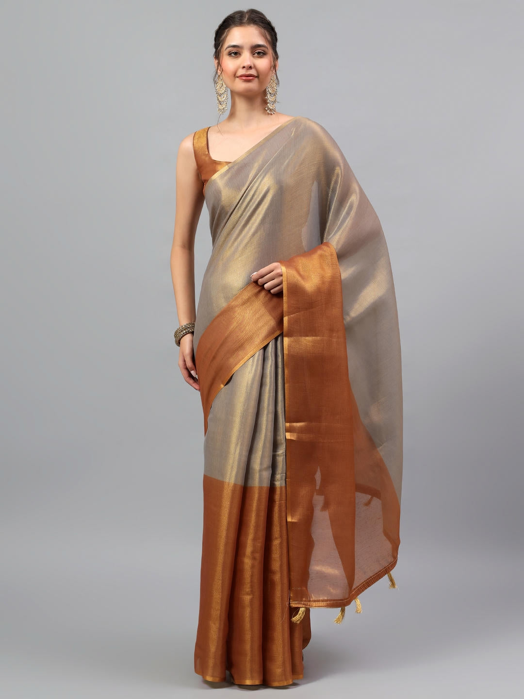 Beautiful woman styled in a majestic espresso brown heavy zari woven silk saree with a contrast pink blouse by Samantha.