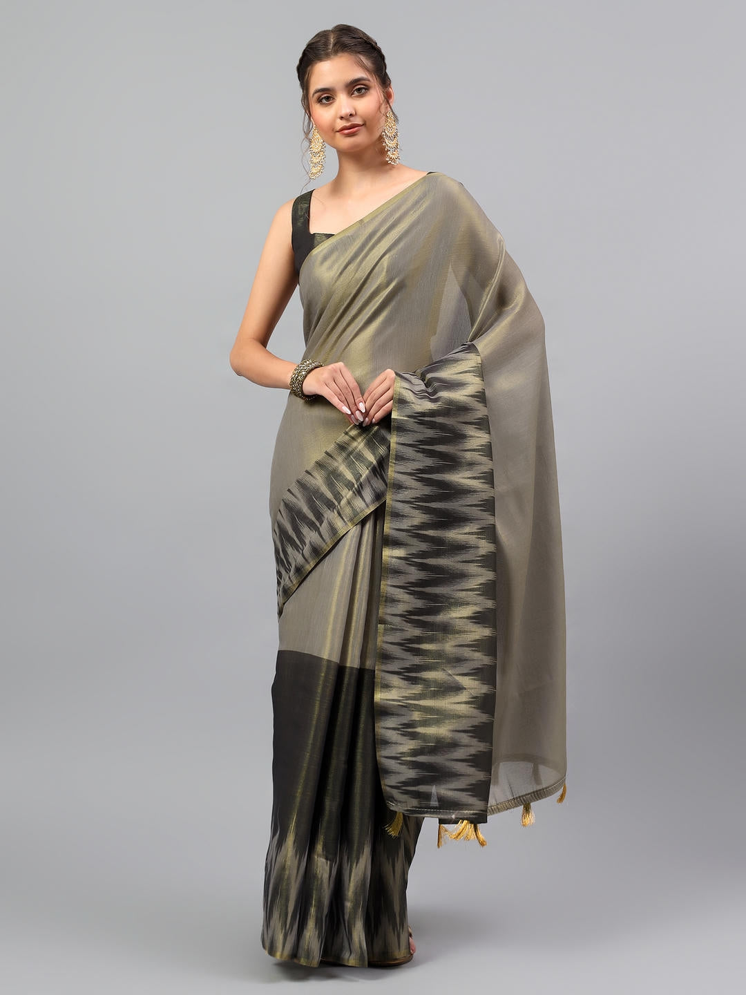 Beautiful woman styled in a glamorous jet black heavy zari woven silk saree with a golden beige contrast blouse by Samantha.