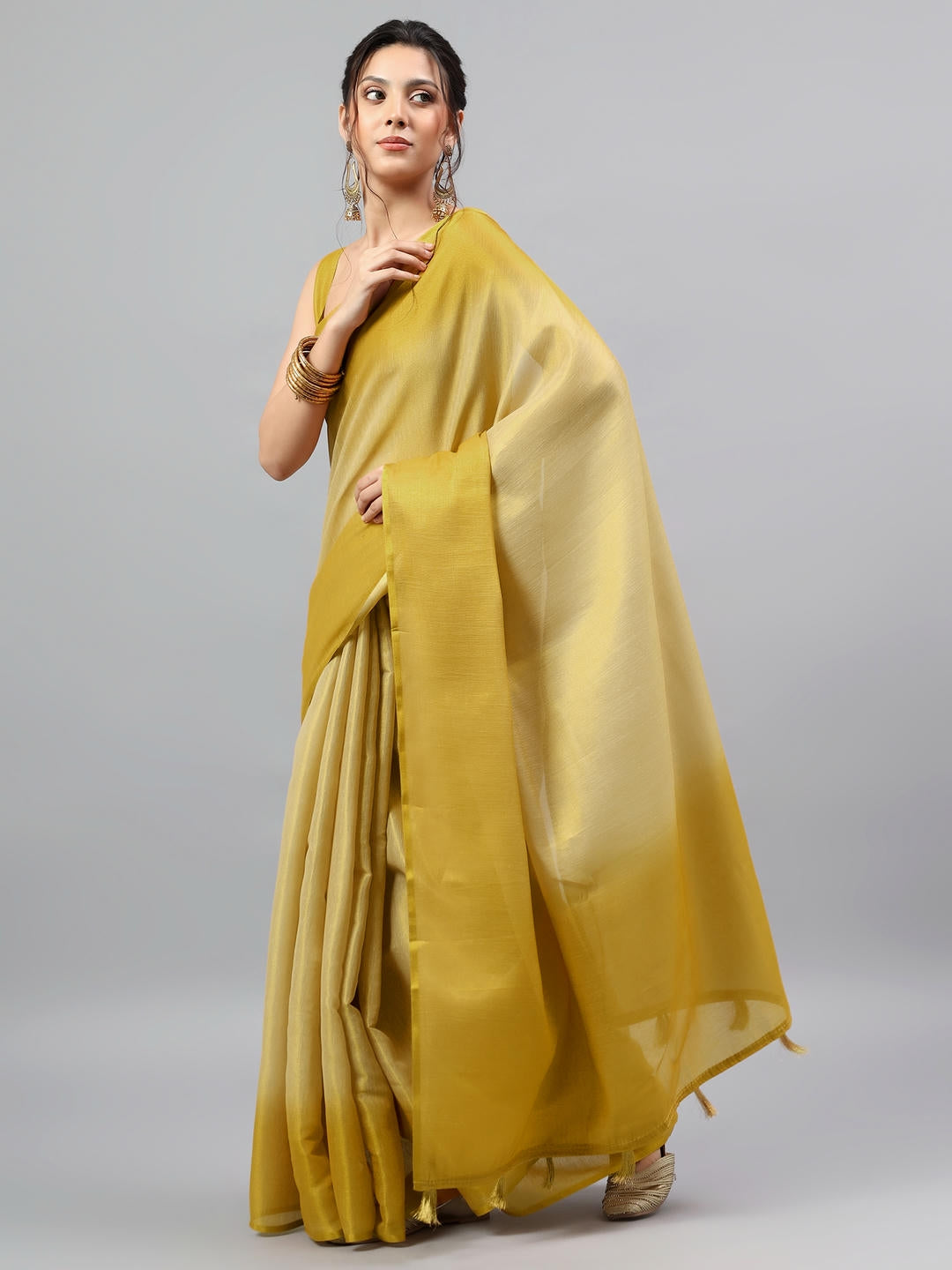 Beautiful woman styled in a majestic pure gold heavy zari woven silk saree with a deep midnight navy contrast blouse by Samantha.