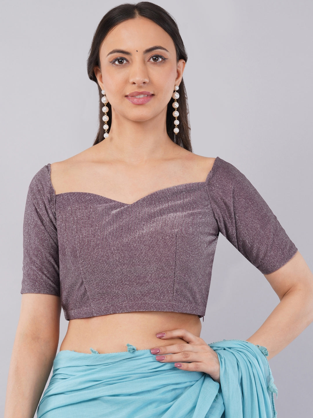 Woman wearing mauve shimmer sweetheart neck blouse with elbow sleeves